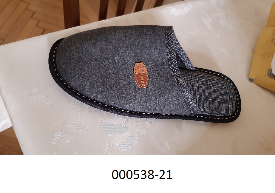 Pantoffel :
- im Fersenbereich offen und mit einem geschlossenen Blatt verarbeitet,
- mit einem Oberteil aus einem Spinnstoff aus einem Gewirke aus Polyester, 
- mit einer nicht profilierten Laufsohle aus Kautschuk,
- mit einer Innensohle länger als 24cm,
- nicht als Frauen- oder Männerschuh erkennbar,
- aufgrund der Verarbeitung für den Innenbereich vorgesehen.
(Abbildung siehe Anlage)