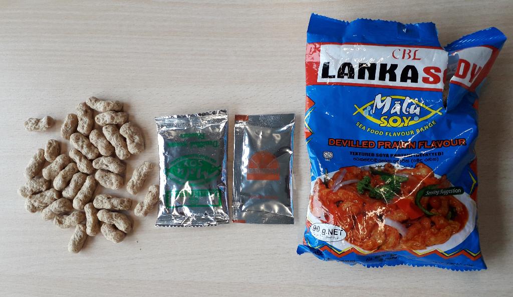 Assortiment de produits alimentaires,
destiné à la préparation d’un plat à base de soja,
composé: 
- de pâtes de soja texturée (dégraissée), séchées, se présentant sous forme de "nuggets", 
- d'un sachet de sauce tomate, et
- d'un sachet d'assaisonnement déshydraté aromatique, au goût de crevettes.
Les pâtes de soja prédominent en poids par rapport aux autres composants.
Les pâtes et les 2 sachets sont conditionnés ensemble pour la vente au détail dans un sachet plastique d'un poids net de 90 g.