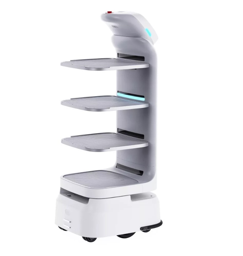 Dle deklarovaných údajů se jedná o inteligentní autonomní servírovací robot, který nabízí rychlé a bezpečné doručování pomocí pokročilé technologie. Jeho navigace pomocí fúze senzorů zajišťuje plynulou navigaci v komplexním prostředí. Systém správy umožňuje snadné nasazení a monitorování více robotů a jeho multimodální interakce zajišťuje efektivní komunikaci se zákazníky. Možnosti přizpůsobení služeb činí robot vhodným pro individuální potřeby. Laserová technologie poskytuje navigaci s centimetrovou přesností a je doplněna 4 různými senzory, které sledují okolí. Robot disponuje čtyřmi tácy s nosností 10 kg pro přepravu pokrmů.
Parametry:
- Rozměry (mm) - 485 x 1265 x 550;
- Hmotnost - 55 kg;
- Displej - 21" ULTRA HD;
- Počet přihrádek - 4;
- Maximální nosnost/prihrádka - 10 kg;
- Maximální velikost obrazovky - 25,6 cm;
- Šířka pojezdu - ≥650 mm;
- Bluetooth Bluetooth - 5.1;
- Kapacita baterie 25,6 V 20 Ah;
- Připojené napětí AC 100-240 V;
- Výstupní napětí DC 29,4 V.