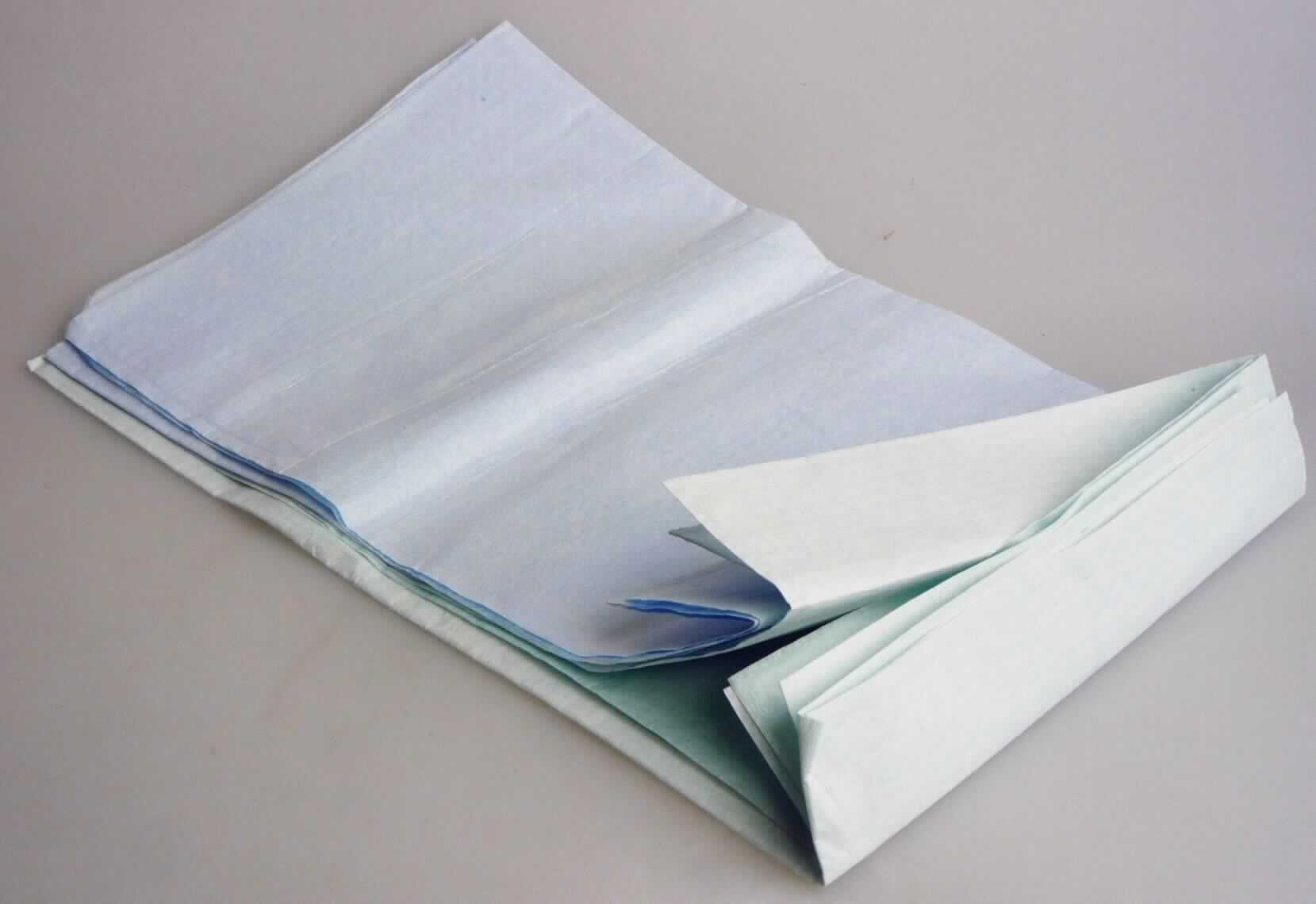 Bei den vorgelegten Warenmustern handelt es sich nach dem vorgelgten Warenmuster und den ergänzenden Angaben der Antragstellerin um sog. Esslätzchen in Form von etwa 36 x 64 cm großen Zuschnitten zweilagiger Flächenerzeugnisse, bestehend aus einer Lage aus weißem Vlies aus Zellstofffasern (Tissue), das einseitig mit einer Lage aus einer dünnen, blauen bzw. grünen Kunststofffolie (lt. Antragstellerin aus PE) überzogen ist, wobei die Dicke der Kunststofflage weniger als die Hälfte der Gesamtdicke des Erzeugnisses ausmacht. Die Lätzchen sind am unteren Rand durch Umschlagen und eine Randverschweißung mit einer etwa 10,6 bzw. 10,1 cm tiefen (Auffang-)Tasche (Krümeltasche) und im oberen Bereich mit einer Perforation zum Heraustrennen zweier Bänder versehen, die das Umhängen des Lätzchens ermöglichen. Die Erzeugnisse dienen in der Patienten- und Altenpflege als Wäscheschutz. 

Abbildung siehe Anlage. 

Derartige aus verschiedenen Stoffen zusammengesetzte Waren gehören als "Bekleidung und Bekleidungszubehör, aus Vliesen aus Zellstofffasern" zum TARIC-Code 4818 50 00 00, da ihr wesentlicher Charakter nach Dicke und Gewicht durch die Vliese aus Zellstofffasern bestimmt wird.