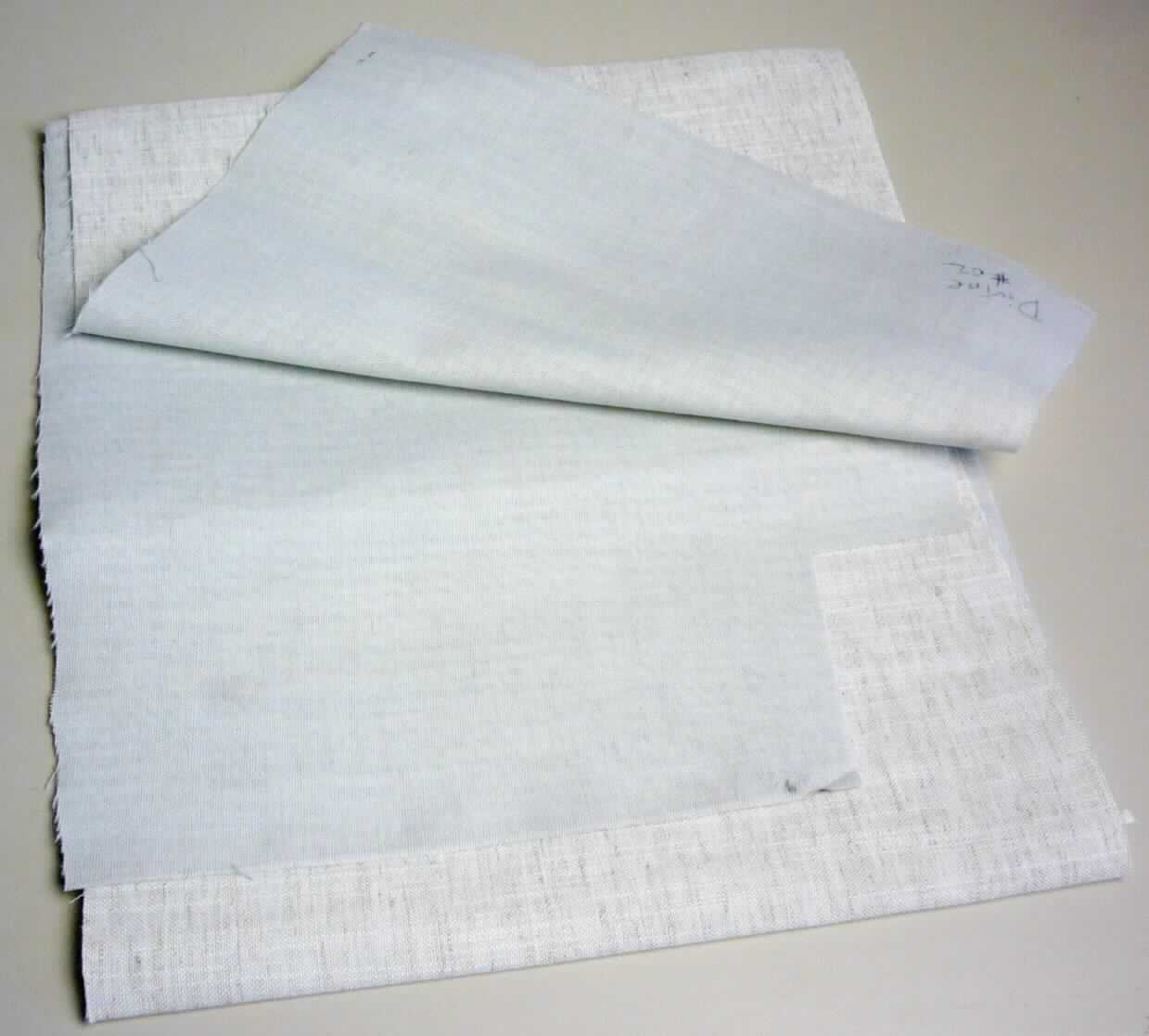 Textillaminat, sog. Möbelbezugsstoff, Foto siehe Anlage,
- als Meterware,
- aus zwei mit ihrer ganzen Fläche aufeinander liegenden und so miteinander durch Kleben verbundenen Lagen, 
  laut Untersuchungsergebnis:
-- mit einer die Schauseite bildenden Außenlage aus einem gebleichten, leinwandbindigen Gewebe
--- aus gebleichten Kettgarnen aus Polyester-Spinnfasern (synthetische Spinnfasern) und Schussgarnen aus 
     gebleichten Polyester-Spinnfasern und rohen Leinenfasern,
--- laut Antrag insgesamt mit einem Anteil an Polyester-Spinnfasern von 95 GHT und einem Anteil an Leinenfasern 
     von 5 GHT; die Angaben können als zutreffend angesehen werden,
-- mit einer Innenlage aus einem gebleichten, leinwandbindigen Gewebe aus Polyester-Spinnfasern.

"Gewebe aus synthetischen Spinnfasern, mit einem Anteil an diesen Spinnfasern von mehr als 85 GHT,
 mit einem Anteil an Polyester-Spinnfasern von mehr als 85 GHT, gebleicht"