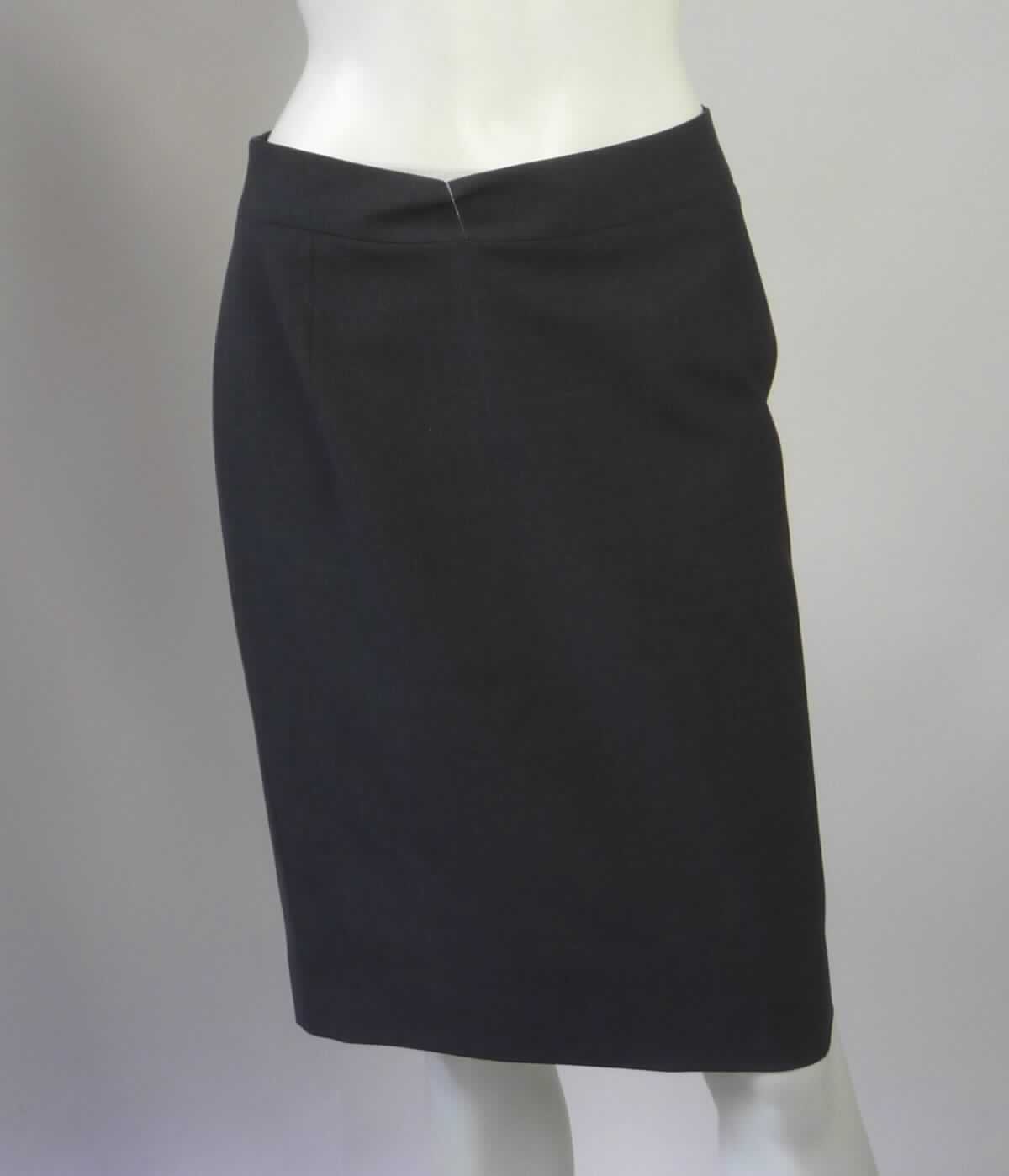 Rock, Größe 36, Foto siehe Anlage,
- aus ca. 0,4 mm dicken, buntgewebten Geweben (melierte Garne) aus laut Antrag 53 % Polyester, 4 % Elasthan
  (beides synthetische Chemiefasern) und 43 % Wolle,
- gefüttert,
- über die Knie reichend (Seitenlänge: ca. 57 cm),
- in der Taille abschließend, mit einem ca. 4,5 cm breiten, angesetzten Bund,
- hinten mit einer ca. 20 cm langen Öffnung mit Reißverschluss und Knopfverschluss im Taillenbund,
- hinten mit einem ca. 17 cm hochreichenden Mittelschlitz,
- am unteren Rand durch Umschlagen und Festnähen gesäumt,
- kann ohne ein weiteres, den Unterkörper bedeckendes Kleidungsstück getragen werden.

"Rock, aus Geweben, für Frauen, aus synthetischen Chemiefasern, nicht nach dem Batik-Verfahren handbedruckt"