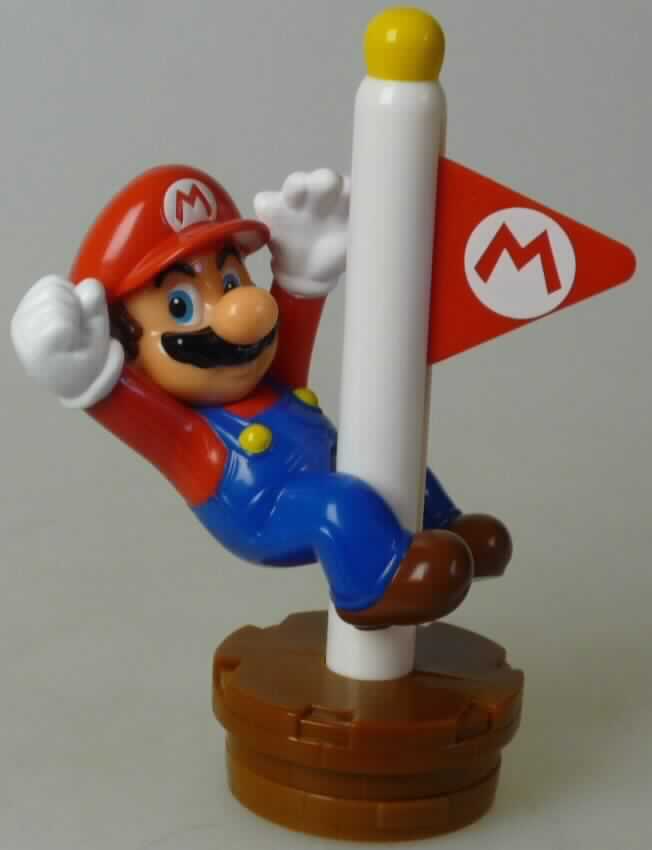 Bei dem aus Kunstsotff bestehenden Motiv "Mario Goal Pole" aus der Serie "Mc Donald's - Furby / Super Mario 2014" handelt es sich um einen Stempel mit einem aufwändig gestalteten Griff mit der Figur "Super Mario". 
In dem runden Sockel (Durchmesser ca. 5 cm, Höhe ca. 2 cm) befindet sich ein rundes, mit Farbe getränktes und mit einem Relief mit dem Gesicht von "Super Mario" ausgestattes Stempelkissen (Durchmesser ca. 1,5 cm). Der Sockel ist mit einem Deckel zum Schutz vor dem Austrocknen der Stempelfläche verschlossen.
Auf dem Sockel befindet sich ein ca. 9,5 cm hoher Pfosten (Griff), an dem sich auf der einen Seite die Figur "Super Mario" befindet, auf der anderen Seite ein roter, dreieckiger Wimpel. Zieht man den Wimpel nach unten/oben, bewegt sich die Figur nach oben/unten. Wimpel und Figur lassen sich vom Pfosten/Griff nicht trennen.

Die in einem Kunststoffbeutel verpackte Ware ist als "Stempel für den Handgebrauch" einzureihen.