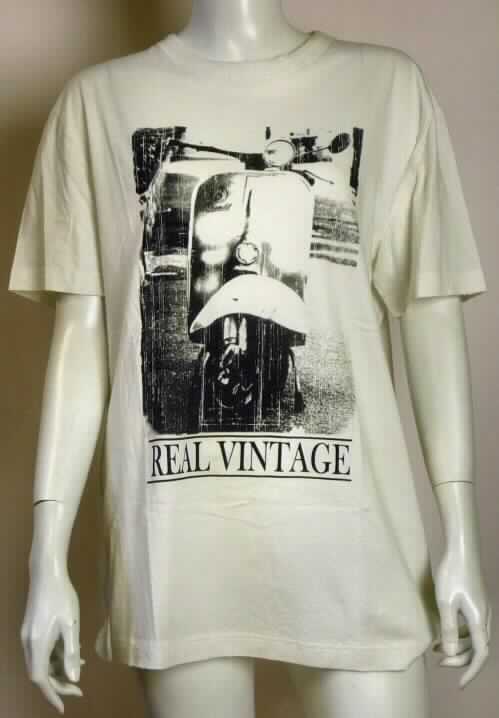 T-Shirt, sog. T-Shirt - Brandit Vintage Tee, Größe M, Foto siehe Anlage,
- aus ca. 0,6 mm dicken (leichten), einfarbigen Gewirken aus lt. Antrag 100 % Baumwolle,
- über den Schritt reichend (Rückenlänge: ca. 71 cm), 
- mit einem runden, halsnahen Ausschnitt,
- ohne Öffnung und ohne Verschluss, 
- mit kurzen, enganliegenden Ärmeln, 
- vorn mit einem großflächigen Aufdruck,
- am unteren Rand durch Umschlagen und Festnähen gesäumt.

"T-Shirt, aus Gewirken, aus Baumwolle"