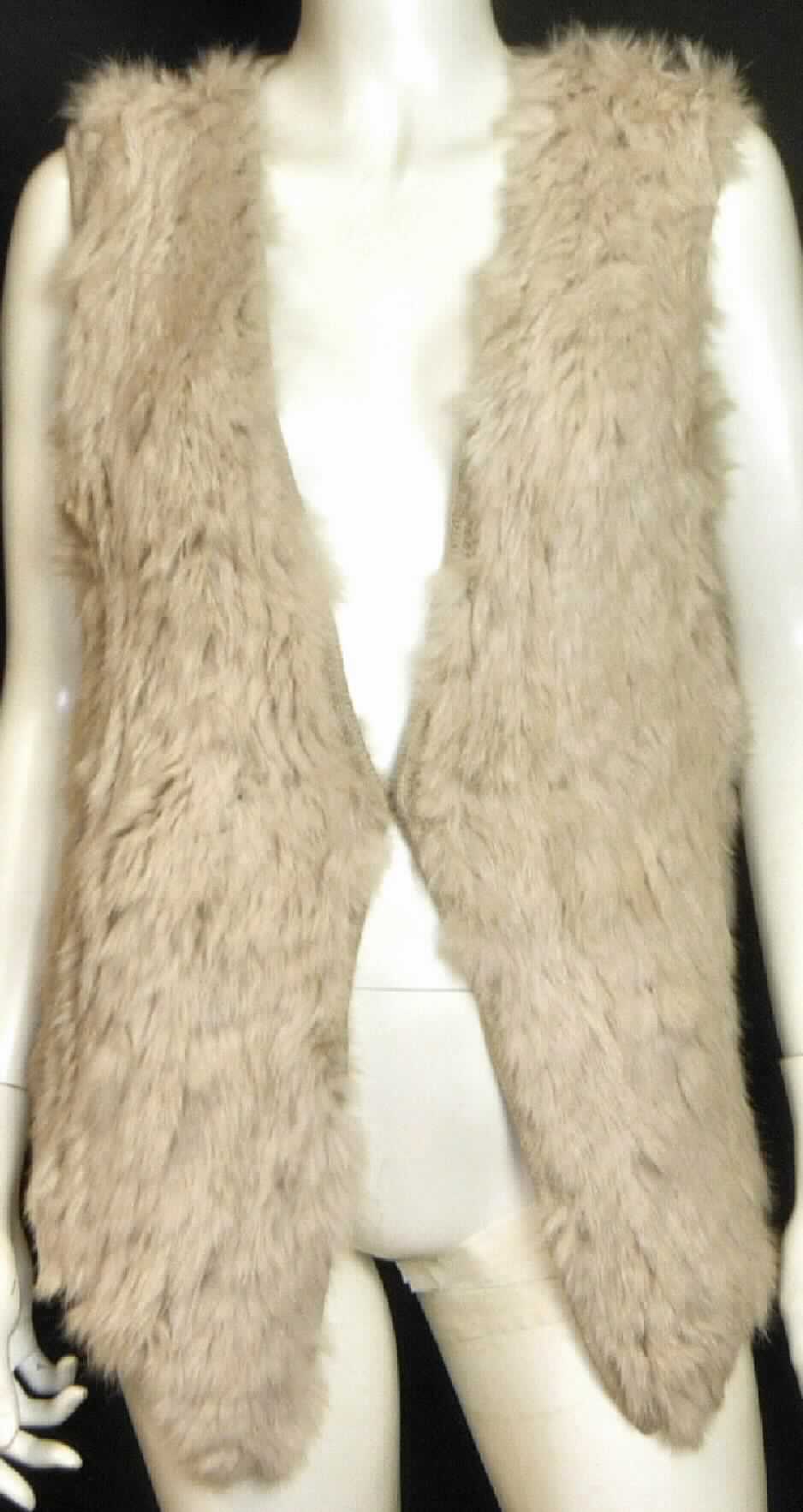 Kleidung aus Pelzfellen, sog. Damenweste Port Sorell Gilet, Art. W04068, 
Abbildung siehe Anlage, 
- aus verschiedenen Stoffen zusammengesetzte Ware, bestehend aus: 
- - zugerichteten Pelzfellen von Hasen oder Kaninchen (lt. Antrag Angora) in Form 
    von ca. 4 mm breiten Streifen, die auf der Vorderseite annähernd flächendeckend 
    das Gewirke aus Wolle (lt. Antrag Merinowolle) durchwirken (geht weit über einen 
    einfachen Besatz hinaus), 
- - Gewirken aus Wolle (lt. Antrag Merinowolle), die die Rückseite des Kleidungs- 
    stückes bilden, 
- ärmelloses Kleidungsstück mit einer Rückenlänge von ca. 58 cm, 
- mit einem V-förmigen Ausschnitt, ohne Kragen, 
- vorne mit einer durchgehenden Öffnung mit einem Hakenverschluss.

"Kleidung (Weste), aus Pelzfellen von Hasen oder Kaninchen"