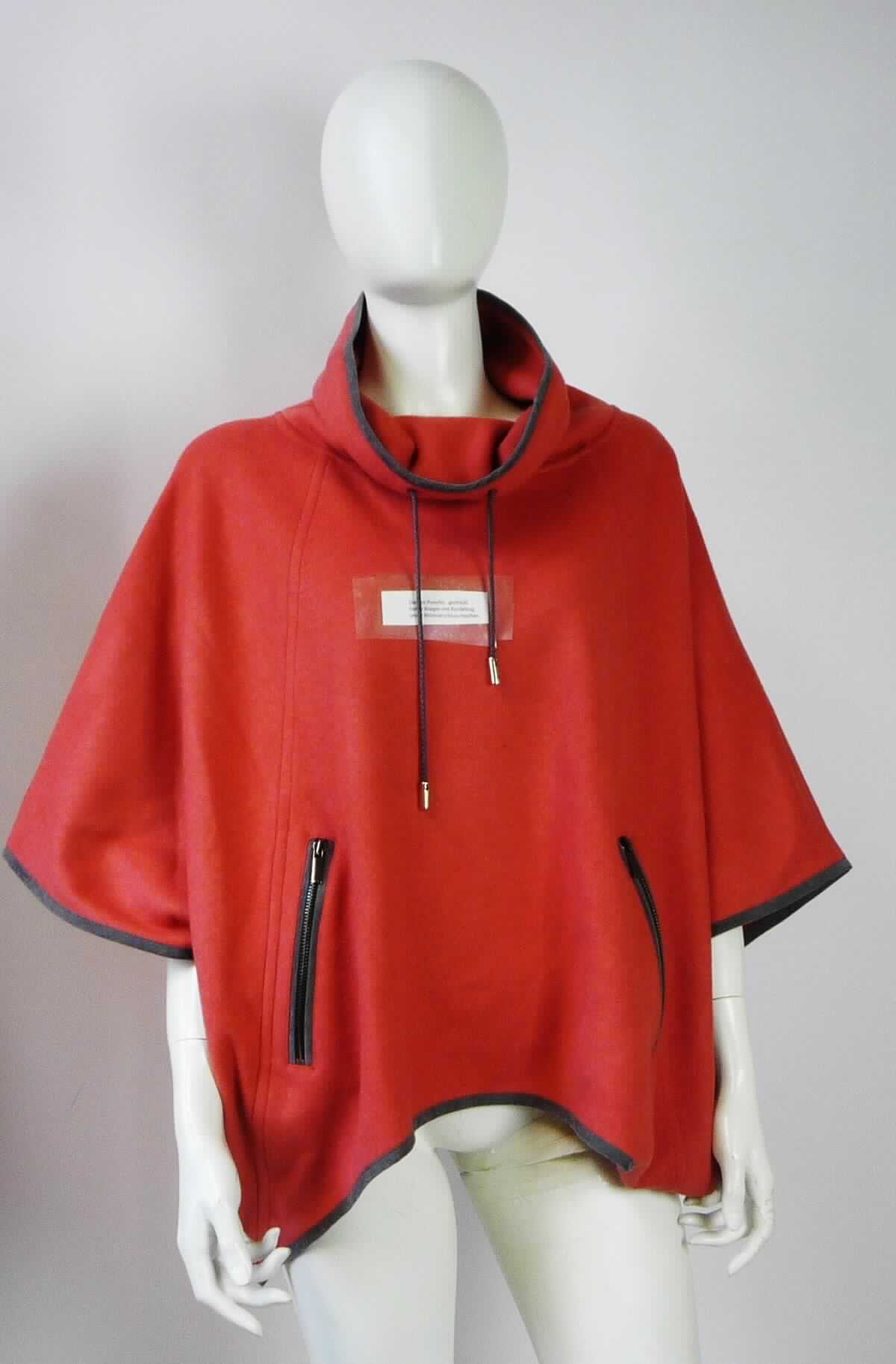 Pullover, sog. Damen Poncho, gestrickt, hoher Kragen, in Erwachsenengröße, Foto siehe Anlage,
- aus ca. 1,9 mm dicken, einfarbigen, beidseitig gerauten Gewirken aus laut Antrag 73 % Schurwolle, 
  25 % Angora (feine Tierhaare) und 2 % Polyamid (synthetische Chemiefasern),
- mit einem Stückgewicht von ca. 556 g,
- über die Taille reichend (Rückenlänge: ca. 67 cm),
- mit einem doppelt gearbeiteten, hohen Kragen mit Tunnelzug am Kragenrand,
- ohne Öffnung und ohne Verschluss, ohne Hinweise auf den Trägerkreis (unisex), 
- mit Armöffnungen, jedoch ohne Ärmel; bedeckt in getragenem Zustand die Schultern und die Oberarme,
- mit zwei eingesetzten Taschen mit Reißverschluss unterhalb der Taille,
- weit geschnitten, in der Art eines Ponchos gearbeitet,
- am unteren Rand bogenförmig gearbeitet und kontrastfarben eingefasst,
- wird aufgrund der Ausstattung (bedeckt die Arme nicht vollständig) im Allgemeinen nicht über jeder anderen 
  Kleidung und zum Schutz gegen das Wetter getragen, somit kein umhangähnliches Kleidungsstück der 
  Position 6102.

" Pullover aus Gewirken, aus Wolle, andere als in der Unterposition 6110 1110 genannte, für Frauen"