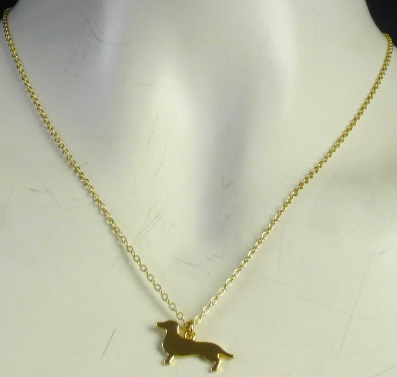 Es handelt sich um Halsketten aus unedlem Metall, bestehend aus einer Gliederkette mit Verlängerungskette und Karabinerhakenverschluss und einem Anhänger in Form eines stilisierten Hundes. Die Halsketten sind vergoldet und an der Verlängerungskette mit einem kleinen runden Anhänger versehen, der mittig mit einem Zirkonia (synthetischer Schmuckstein) besetzt ist. 
-Antragstellerangaben-

Eine Einreihung als Fantasieschmuck in die Position 7117 kommt nicht in Betracht, da die Erzeugnisse einen synthetischen Schmuckstein enthalten.

Abbildung siehe Anlage.

Derartige Erzeugnisse gehören als "andere (als in dem TARIC-Code 7116 2011 00 genannte) Waren aus Edel- oder Schmucksteinen" zum TARIC-Code 7116 2080 00.