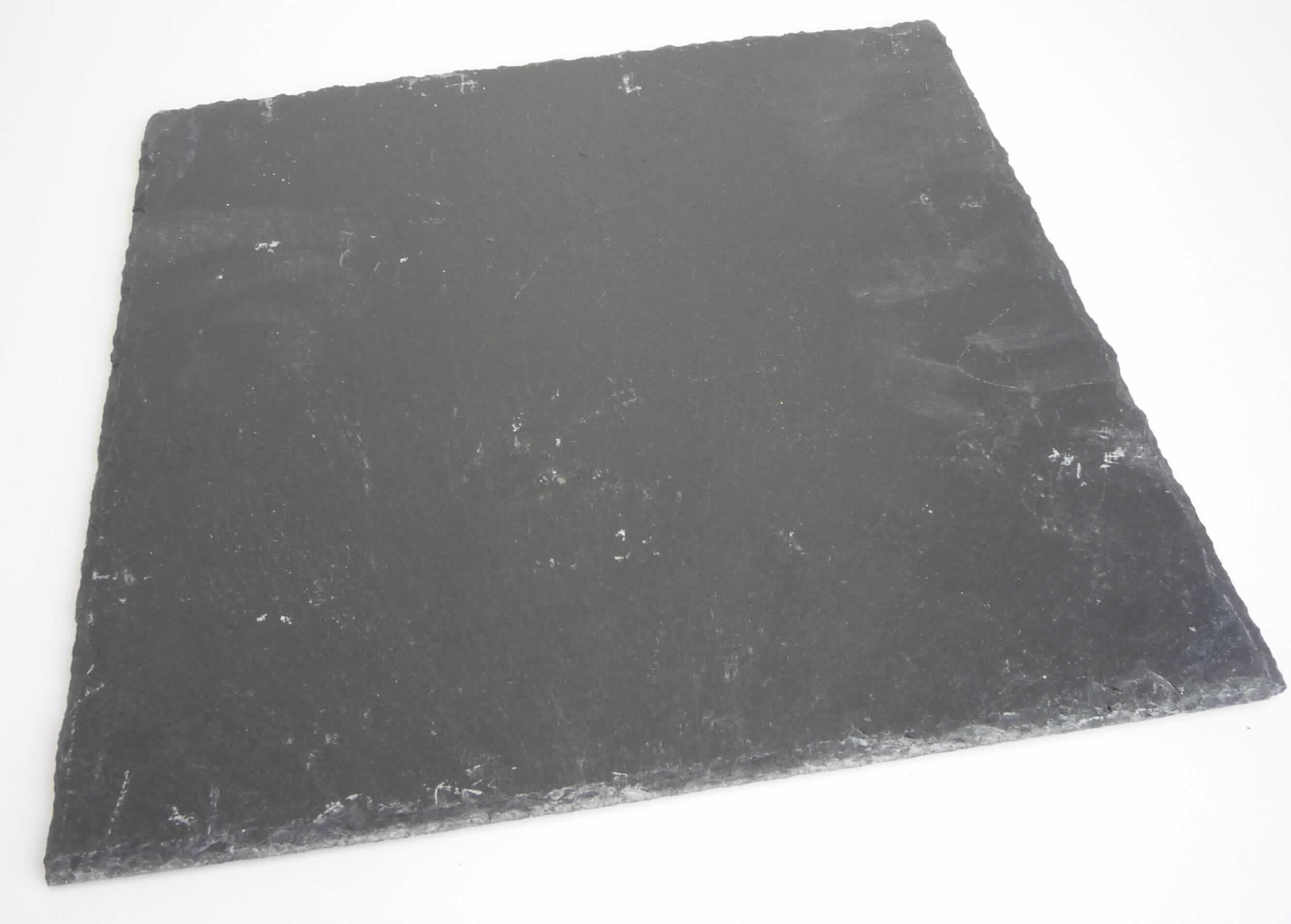 Angaben:
Schieferplatte, schwarz, Größe: 30 x 30 cm.

Warenbeschaffenheit:
Quadratische, flache, schwarze Steinplatte mit bearbeiteten Kanten und vier Schonern auf der Unterseite.

Befund:
Bearbeiteter Tonschiefer und Waren aus Tonschiefer oder aus Pressschiefer