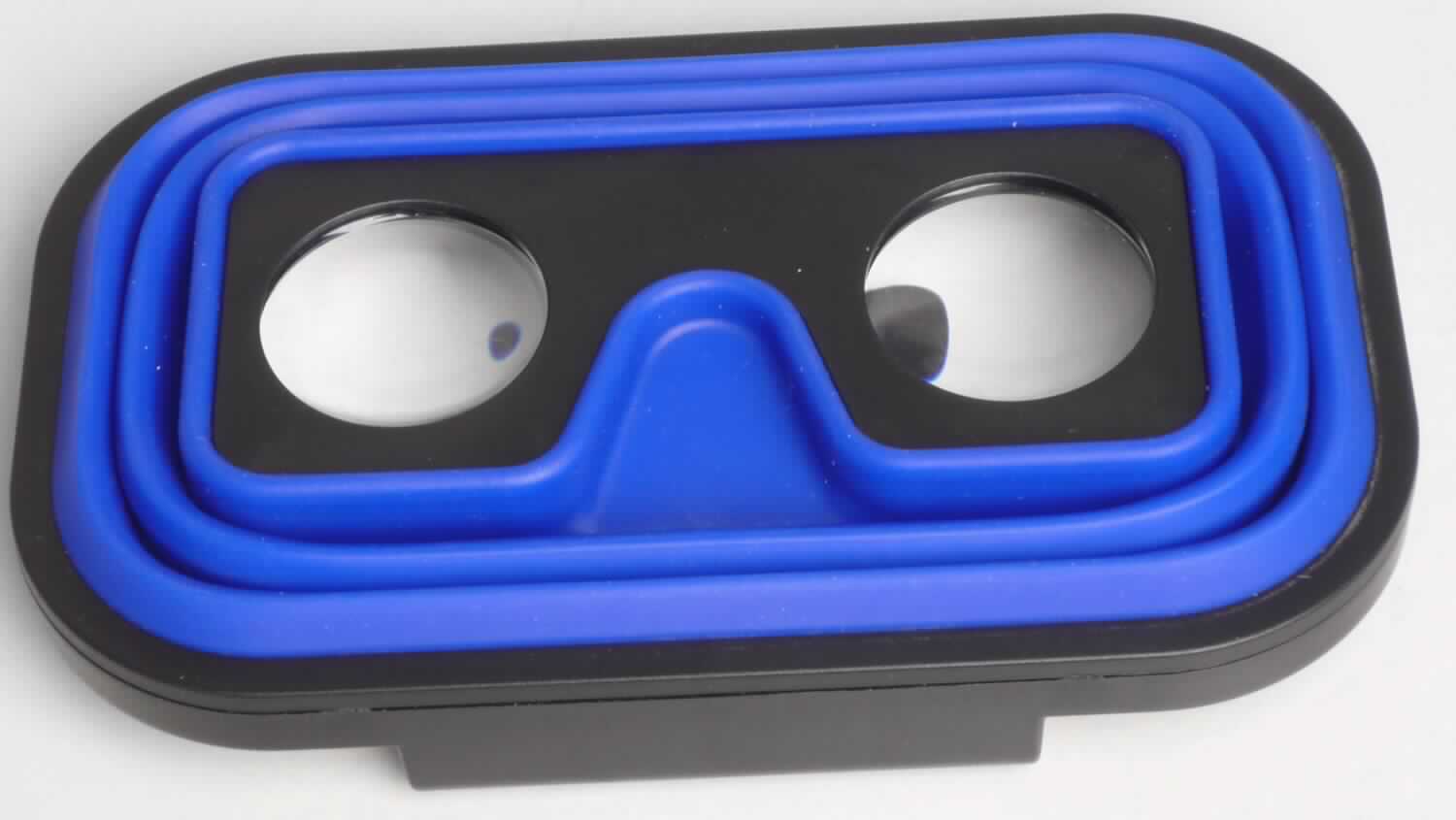Sog. VR-Brille "Entertainment", im Wesentlichen bestehend aus einem Kunststoffstoffrahmen mit Clip zum Befestigen des Smartphones, einer Kunststofffassung für zwei optische Linsen aus Kunststoff und einem auffaltbaren Silikon Falz (äußere Form siehe Abbildung).
Das Gerät als dient als Vorrichtung zum Betrachten von auf Smartphone abgespielten Videos im 3D-Format.

Ware wird als "brillenähnliche Ware, keine Sonnenbrille, mit Brillengläsern aus Kunststoffen" eingereiht.