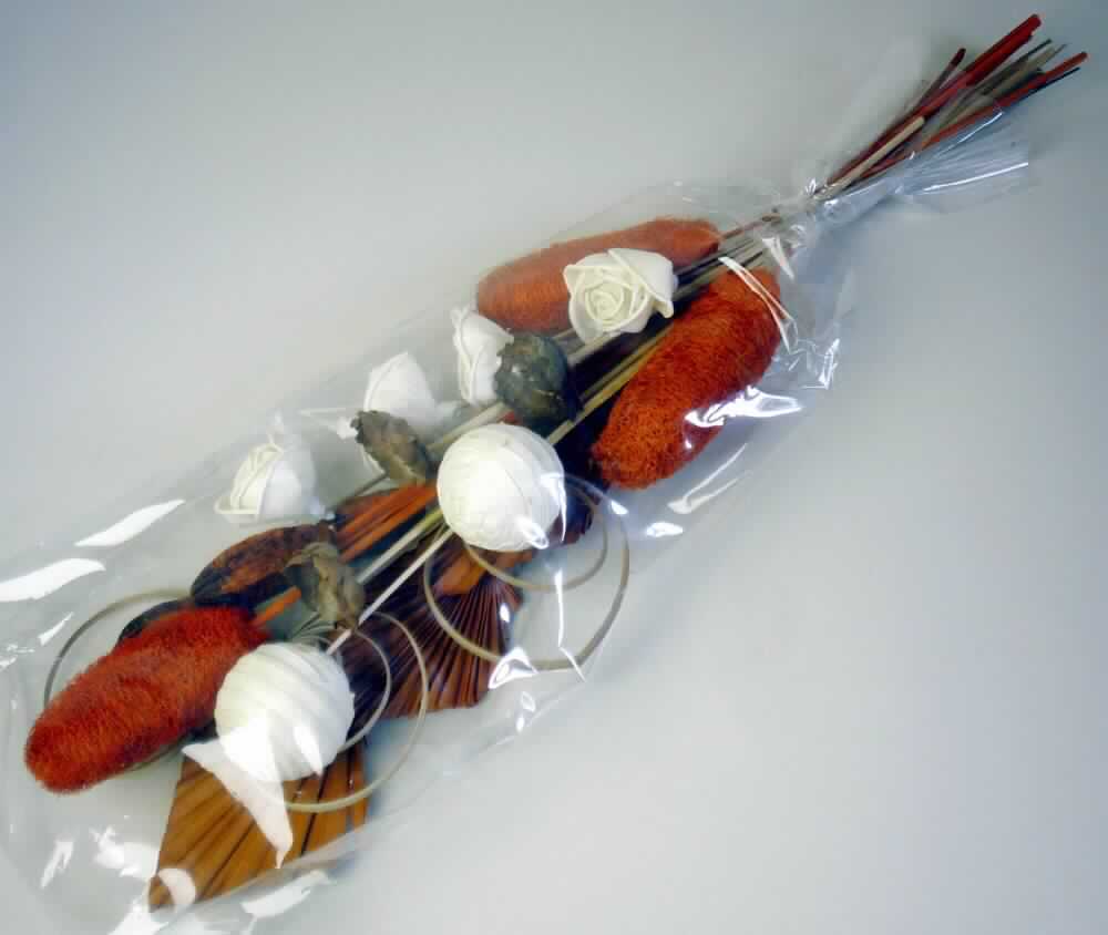 Grabschmuck 21er Pack, orange, Art.Nr. 82684
Warenzusammenstellung aus:
- 14 getrockneten und gefärbten Pflanzenteilen (3 Palm Spear, 3 Mehagony = Fruchtstände auf 
  einem Stab, 3 Cane Coil = spiralförmige gedrehte Pflanzenstreifen, 3 Cocos Blumen = Frucht-
  trageblätter der Kokosnusspalme auf einem Stab, 2 Sola ball = Pflanzenstreifen von Aeschyno-
  mene Aspera auf einer Kunststoffkugel mit Stiel aufgeklebt), 4 in Blumenbindetechnik hergestell-
  ten künstlichen Blumen/Blüten (white roses = natürliche Pflanzenscheiben bzw. -streifen von 
  Aeschynomene Aspera auf einem Stab/Grashalm zu einer Blume/Blüte miteinander verbunden)
  und 3 Waren aus Luffa (gefärbte Luffa jeweils auf einem Stab aufgebracht),
- zum Fertigen von Grabgestecken,  
- gemeinsam in einer Kunststofffolie verpackt, in Aufmachung für den Einzelverkauf,
- wird üblicherweise vom Blumenhandel zu Binde- und Zierzwecken geliefert.
(Abbildung siehe Anlage)

Der Charakter der Warenzusammenstellung wird hinsichtlich der Menge durch die getrockneten und gefärbten Pflanzenteile bestimmt. 

"Pflanzenteile, ohne Blüten und Blütenknospen, zu Binde- oder Zierzwecken, getrocknet, keine Moose und Flechten, gefärbt (weitergehend bearbeitet als nur getrocknet; Warenzusammenstellung aus Pflanzenteilen -charakterbestimmend-, künstlichen Blüten und Waren aus Luffa)"