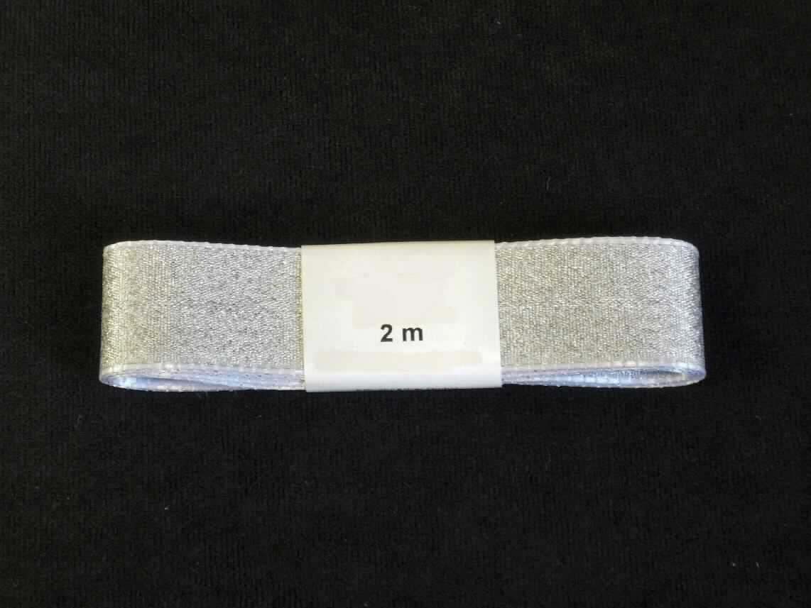 Band, sog. Band silber, Art.-Nr. 322-078, Foto siehe Anlage,
- als Meterware mit einer Länge von laut Antrag 2 m; mit einer Papierbanderole umhüllt,
- laut Untersuchungsergebnis:
-- mit einer Breite von ca. 2,5 cm,
-- aus einem Gewebe mit Kettfäden aus synthetischen Chemiefasern und Schussfäden aus metallisierten Garnen 
   (ca. 1 mm breite, metallisierte Streifen aus synthetischer Spinnmasse, die kreuzweise mit zwei Monofilen 
   umwickelt sind),
-- mit einem Anteil an synthetischen Chemiefasern von 54,5 GHT und an metallisierten Garnen von 45,5 GHT,
-- mit echten Webkanten an beiden Längsseiten,
-- keine Elastomergarne oder Kautschukfäden enthaltend.

"Band, keine Ware der Position 5807, kein Samt, Plüsch, Chenille- oder Schlingengewebe, keine Elastomergarne 
 oder Kautschukfäden enthaltend, aus Chemiefasern, mit echten Webkanten"