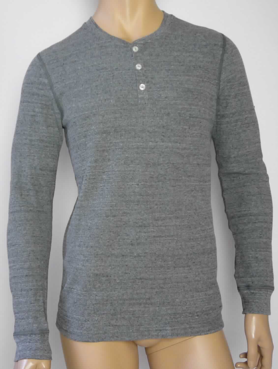 Hemd, sog. Thermal Shirt, Art. WT457, Größe M, Foto siehe Anlage,
- aus ca. 1,3 mm dicken, strukturiert und buntgewirkten Gewirken (melierte Garne) aus laut Antrag 
  58 % Baumwolle, 39 % Polyester und 3 % Elasthan (beides synthetische Chemiefasern), mit durchschnittlich 
  mehr als zehn Maschen je linearen Zentimeter in jeder Richtung,
- über die Taille reichend (Rückenlänge: ca. 69 cm),
- mit einem runden Ausschnitt, mit einer schmalen Randeinfassung,
- vorn mit einer nicht durchgehenden Öffnung mit Knopfverschluss von links über rechts (Männerkleidung), 
- mit langen Ärmeln, an den Ärmelenden mit angesetzten, doppelt gearbeiteten Bündchen,
- am unteren Rand durch Umschlagen und Festnähen gesäumt.

"Hemd für Männer, aus Gewirken, aus Baumwolle"