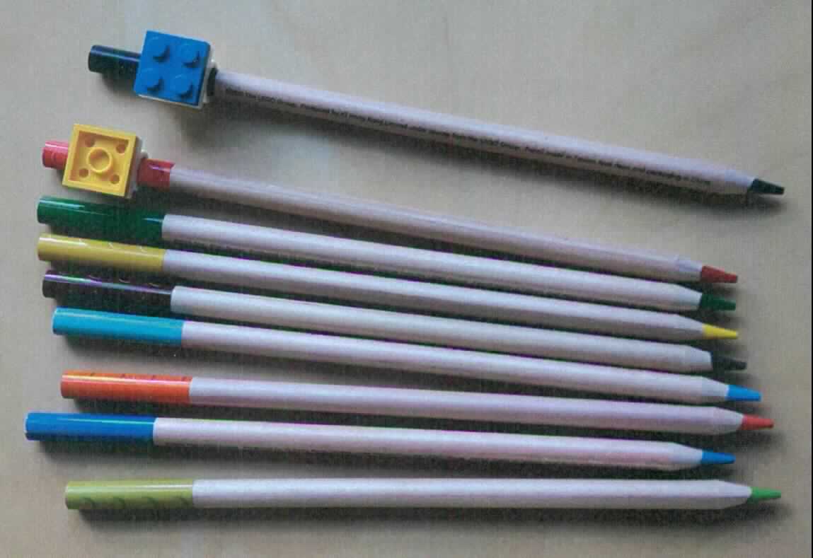 Bei dem sog. "Set mit 9 verschieden farbigen Buntstiften" handelt es sich um neun ca. 17,5 cm lange Farbstifte in den Farben rot, orange, gelb, grün, dunkelgrün, blau, dunkelblau, braun und schwarz. 

Die Stifte besitzen einen festen Schutzmantel und sind gemeinsam mit zwei kleinen Legosteinen als Topper (Gegenstände von geringer Bedeutung) in einer bedruckten Pappschachtel aufgemacht. 

Die Ware ist als "Farbstifte mit festem Schutzmantel, andere als Bleistifte" einzureihen.