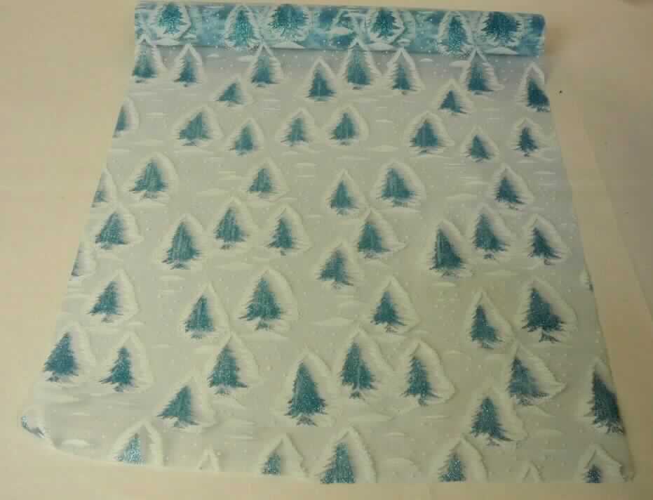 Gewebe, sog. Deko-Stoffrolle, blau mit Tannenbaummotiv, Foto siehe Anlage,
- in einer klarsichtigen Kunststofffolie verpackt,
- als Meterware auf einer Rolle aus Pappe; mit einer Breite von ca. 38 cm,
- laut Untersuchungsergebnis:
-- in Leinwandbindung,
-- aus ungezwirnten, nicht hochfesten Garnen aus synthetische Filamenten (Polyamid),
-- mit Farbe und musterbildend mit kleinen, metallisierten Kunststoffpartikeln (Glitter) bedruckt,
- an den Längskanten heiß geschnitten.

"Gewebe aus Garnen aus synthetischen Filamenten, anderes als in den Unterpositionen 5407 10 bis 5407 30 
 genannte, mit einem Anteil an Filamenten aus Polyamiden von mehr als 85 GHT, bedruckt"