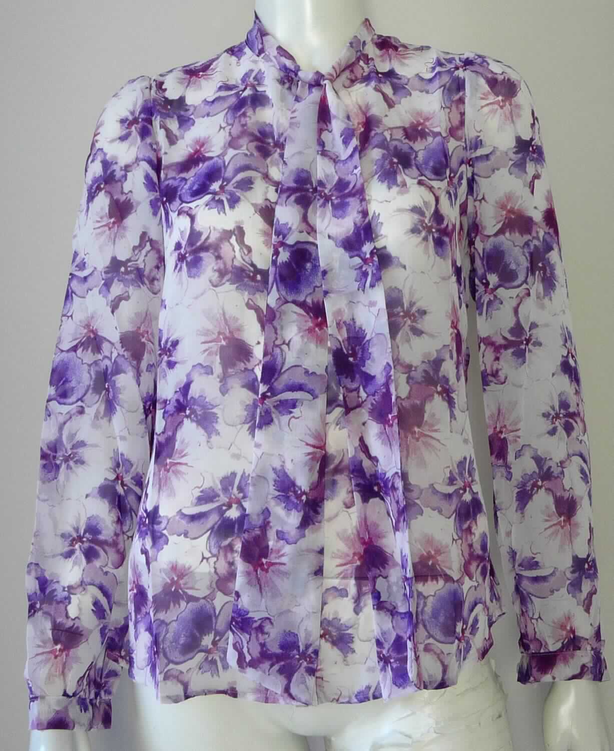 Hemdbluse, Art. RSACF309, Größe XS, Foto siehe Anlage,
- aus ca. 0,1 mm dicken, bedruckten Geweben aus laut Antrag 100 % Polyester (synthetische Chemiefasern), 
- über die Taille reichend (Rückenlänge: ca. 65 cm), 
- mit einem schmalen Stehkragen, vorn mit Verlängerungen in Form von Bindebändern,
- vorn mit durchgehenden Öffnung mit Knopfverschluss von rechts über links (Frauenkleidung),
- mit langen Ärmeln, mit manschettenartigen Abschlüssen,
- am unteren Rand durch Umschlagen und Festnähen gesäumt,
- den Hemden für Männer entsprechend zugeschnitten.

"Hemdbluse, aus Geweben, für Frauen, aus Chemiefasern"
