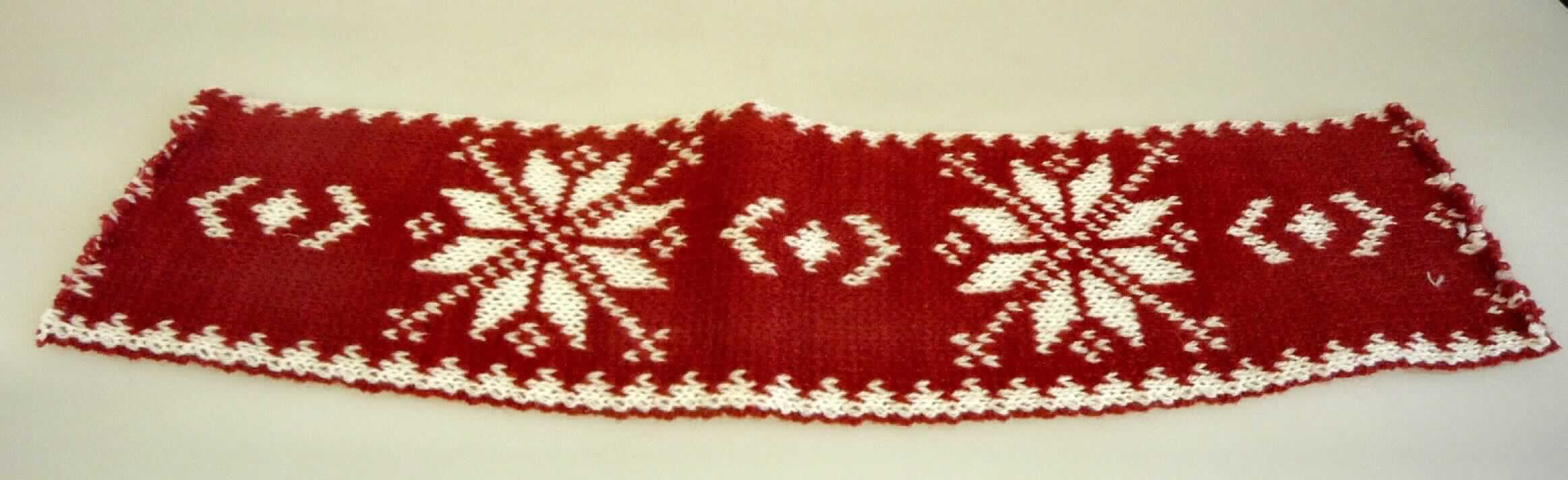 Gewirke, sog. Strickband, Art.-Nr. 552219, Foto siehe Anlage,
- laut Antrag als Rolle aufgemacht, mit einer Länge von 2 m und einer Breite von 9,5 cm,
- aus buntgewirkten (Schneeflockenmotiv) Doppelgewirken aus laut Antrag 100 % Wolle,
- keine Elastomergarne oder Kautschukfäden enthaltend,
- ohne Flor- oder Schlingenoberfläche.

"Gewirke, mit einer Breite von weniger als 30 cm, anderes als solche der Positionen 6001 und 6002, aus Wolle"