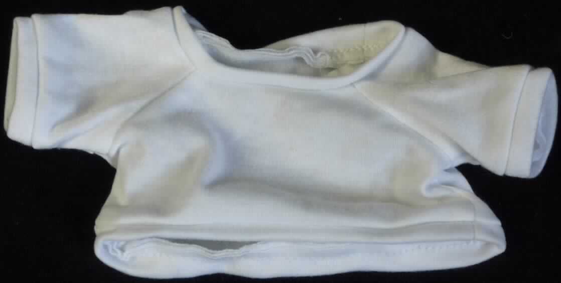 Es handelt sich um ein ca. 9,5 x 20 cm (HxB; Breite mit Ärmeln) großes, weißes T-Shirt aus Spinnstoff mit einem runden Halsausschnitt und kurzen Ärmeln. Der Kragenbereich, die Ärmelenden und der gerade, untere Rand des Shirts sind mit einem Bund ausgestattet.

Das T-Shirt ist aufgrund der Gestaltung erkennbar hauptsächlich als Zubehör für Puppen bestimmt. Eine mögliche Verwendung als Zubehör für Plüschtiere steht der Einreihung nicht entgegen. 

Die Ware dient der spielerischen Unterhaltung von Kindern mit Puppen.

Das Erzeugnis ist als "Zubehör für Puppen, nur Nachbildungen von Menschen darstellend" einzureihen.
