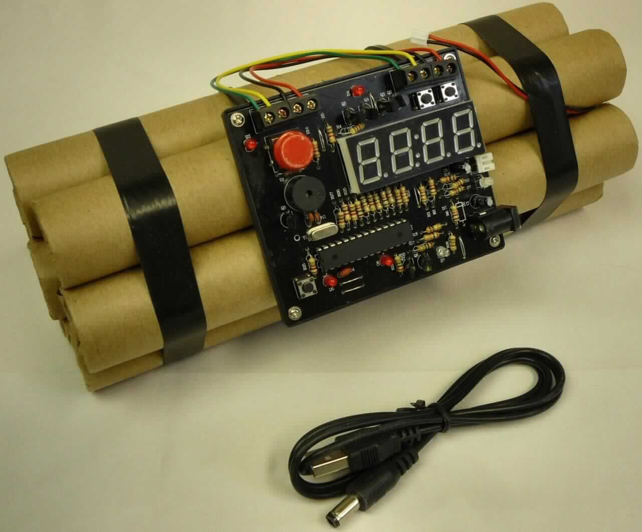 Sog. 2-Tech Uhr, Mod. Bombe, Art. 20001483 in Form eines Weckers, s. Foto, bestehend aus sieben durch Kunststoffbänder verbundene Papprollen ("Dynamitstangen"), eine stilisierte Bombe darstellend und einem darauf befestigten quadratischen Kunststoffträger (ca. 9. x 8 cm) als Uhrwerk mit einer vierstelligen Digitalanzeige für Stunde, Minute und Weckzeit, entsprechenden Bedienungselementen, Kabeln und Drähten.
Das Display zeigt Uhrzeit und Weckzeit an. Mittels eines roten Knopfes kann der Alarm vorzeitig in Betrieb genommen werden.
Der Wecker ist batteriebetrieben; er kann auch mit einem USB-Kabel an den Strom angeschlossen werden.
Das Erzeugnis ist in einem Sichtkarton aus Kunststoff aufgemacht.

Die beschriebene Ware ist als "andere - als in den Pos. 9101 bis 9104 erfasste Uhr
(Wecker), elektrisch betrieben" einzureihen.