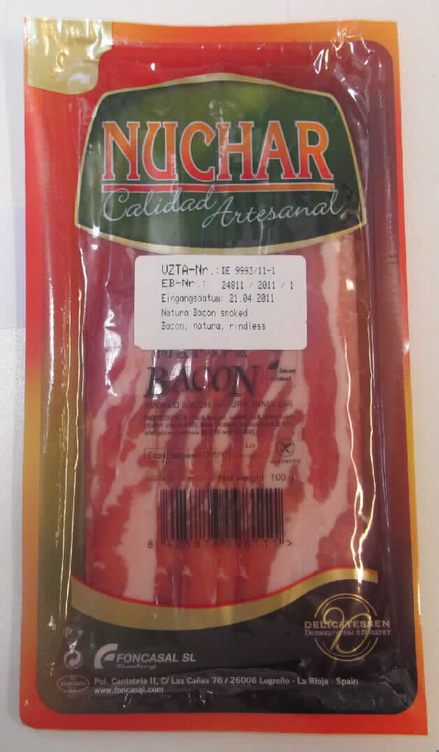 Angaben des Antragstellers: Natura Bacon smoked Bacon, natura, rindless
Ingredients: Pork Bacon, water, salt, stabilizers (E 452) milk protein, antioxidant (E 316) and preservatives: (E 250 and E 262)

Ergebnis der Untersuchung einer Warenprobe:

Aufmachung: 1 klarsichtige Vakuumpackung mit 7 Scheiben.
Kennzeichnung (Auszug): NUCHAR, Calidad Artesanal, Natura Bacon, SMOKED BACON, NATURA RINDLESS; Net weight 100 g. Genusstauglichkeitszeichen ES 10.06996/LO C.E.

Äußere Beschaffenheit: 
Rohes, gepökeltes und geräuchertes Schweinefleisch, durchwachsen, ohne Schwarte und Knochen, in Scheiben geschnitten.
Abmessungen ca. (cm): 21,5 x 2,5 x 0,2
Eigengewicht ca. 98,3 g

Analytische Daten:
Verhältnis Wasser/Protein (ISO 937-1978, N x 6,25): größer als 2,8 %
Salzgehalt (potentiometrisch): 3,5 %