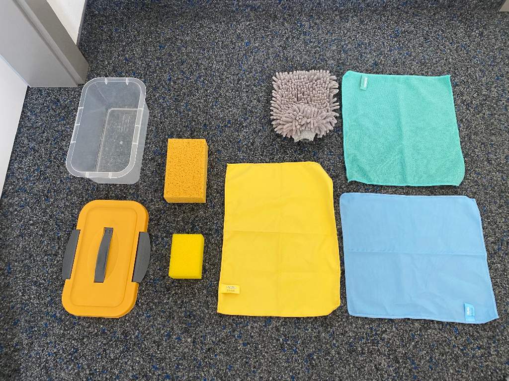 Autoreinigungsset, sog. AUTO-PUTZ-BOX, Foto siehe Anlage,
- Warenzusammenstellung, bestehend aus vier Reinigungstüchern und zwei Autoschwämmen,
  gemeinsam in einer wiederverschließbaren Box aus Kunststoff für den Einzelverkauf aufgemacht
  und zur Befriedigung eines speziellen Bedarfs zusammengestellt,
- Reinigungstücher:
-- in rechteckiger Form; an den Rändern durch Überwendlichnähte gesäumt (somit konfektioniert),
-- sog. Chenille-Mikrofaser-Handschuh:
--- ca. 23 cm x 16 cm; als Reinigungshandschuh gearbeitet und so verwendet (damit keine Ware der
    Unterposition 6307 90),
--- auf der einen Seite aus einem getufteten Spinnstofferzeugnis der Position 5802 (Gewebe mit einge-
    arbeiteten Chenillegarnen); auf der anderen Seite zweilagig gearbeitet: mit einer Außenlage aus ein-
    farbigen Schlingengewirken und einer Innenlage aus augenscheinlich Schaumkunststoff (Meterware
    der Position 6001); alle textilen Flächenerzeugnisse aus laut Antrag 100 % Polyester (synthetische
    Chemiefasern),
--- an einer Schmalseite offen, an den beiden Längs- und der anderen Schmalseite zusammengenäht;
     mit einem ca. 4 cm breiten, angenähten, elastischen Bund versehen; ohne Hinweise auf Handarbeit,
--- aufgrund der Verarbeitung als Reinigungshandschuh ohne Daumen liegt kein Handschuh der Position
     6216 vor,
--- im Hinblick auf die Verwendung sind die Gewebe und Gewirke gleichbedeutend; somit bestimmt
     keines der beiden Flächenerzeugnisse den wesentlichen Charakter des Reinigungshandschuhs;
    er ist damit der von den gleichermaßen in Betracht kommenden Unterpositionen (6307 1010 bzw.
    6307 1090) in der Nomenklatur zuletzt genannten zuzuweisen,
-- sog. Mikrofasertuch STAUB: ca. 40,5 cm x 30 cm; ca. 0,4 mm dicken, beidseitig gerauten Geweben
   aus laut Antrag 90 % Polyester und 10 % Polyamid (synthetische Chemiefasern); ohne Hinweise auf
   Handarbeit,
-- sog. Mikrofasertuch INTENSIVE: ca. 35 cm x 32 cm; aus ca. 1,9 mm dicken, einfarbigen Schlingen-
   gewirken aus laut Antrag 100 % Polyester,
-- sog. Mikrofasertuch GLAS: ca. 35 cm x 32,5 cm; aus ca. 0,6 mm dicken, einfarbigen Gewirken aus
   laut Antrag 85 % Polyester und 15 % Polyamid,
- Autoschwämme:
-- quaderförmig; ca. 10 cm x 7 cm x 5 cm (sog. Insektenschwamm) bzw. ca. 16,5 cm x 10 cm x 5 cm
   (sog. Waschschwamm),
-- aus augenscheinlich geschäumten Kunststoffen im Sinne der Anmerkung 1 zu Kapitel 39 (laut Antrag:
   Polypropylen bzw. Polyurethan),
- insbesondere im Hinblick auf die Menge überwiegen die Reinigungstücher gegenüber den Auto-
  schwämmen; innerhalb der Position 6307 überwiegen insbesondere im Hinblick auf die Menge weder
  die Reinigungstücher aus Gewebe (Reinigungshandschuh, Staubtuch) noch die Reinigungstücher aus
  Gewirke (Mikrofasertücher INTENSIVE und GLAS); die Warenzusammenstellung ist somit der von den
  gleichermaßen in Betracht kommenden Unterpositionen (6307 1010 und 6307 1090) in der Nomenklatur
  zuletzt genannten zuzuweisen. 

"Andere konfektionierte Ware (Reinigungstücher), aus Spinnstoffen, andere als in den Unterpositionen
 6307 1010 und 6307 1030 genannte, nicht handgearbeitet"