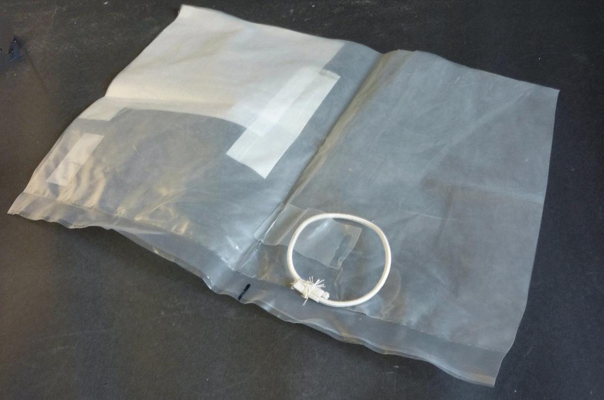 Nach den Angaben der Antragstellerin handelt es sich um ein sog.  "Linerbag" aus miteinander verschweißten Folien aus Polyethylen, einem Kunststoff im Sinne der Anmerkung 1 zu Kapitel 39.

Das schlauchförmige, quaderförmige Erzeugnis (Abmessungen für 20' Container: 2,40 m x 2,40 m x 5,80 m bzw. für 40' Container: 2,40 m x 2,40 m x 11,80 m) verfügt auf einer Stirnseite im oberen Bereich über Tüllen zur Beladung und Entlüftung und im unteren Bereich über eine vorgesehene Entladeöffnung (-tülle), die durch Aufschneiden geöffnet wird. Ferner ist das "Linerbag" mit aufgeschweißten bzw. aufgeklebten gummielastischen Ringen zur Befestigung versehen. Zusätzlich ist das Erzeugnis unterhalb der Tüllen zur Beladung und Entlüftung, bis etwa einem Meter unter den Bodenbereich des Linerbags reichend, mit einem sog. "Türschott" aus einem Gewebe aus Streifen aus synthetischer Spinnmasse aus Polyethylen (Streifenbreite augenscheinlich weniger als 5 mm, ein Bestreichen mit Kunststoff ist mit bloßem Auge nicht wahrnehmbar), ausgestattet. Das "Türschott" dient als Schutz des "Linerbags" vor Beschädigungen.
 
Gemäß den Angaben der Antragstellerin wird das zum Auskleiden von Containern vorgesehene "Linerbag" mit Gewebebändern und Befestigungskomponenten aus unedlen Metallen (Karabinerhaken, Schellen, Ringen) im Container befestigt, dient zu Transport- oder Verpackungszwecken von großen Mengen von fließfähigen Schüttgütern und ist für eine längere Verwendung nicht vorgesehen.

Das Linerbag und die Spinnstoffgurte sowie die Befestigungskomponenten sind (lt. Angaben der Antragstellerin) in einer gemeinsamen Verpackung aufgemacht.

Im Hinblick auf die Bedeutung in Bezug auf die Verwendung und den Umfang bestimmen die Folien aus Polyethylen den Charakter der Ware.

Derartige Erzeugnisse werden zolltarifrechtlich als "Transport- oder Verpackungsmittel aus Kunststoffen, andere als von den TARIC-Codes 3923 1010 00 bis 3923 5090 00 erfasst" eingereiht.