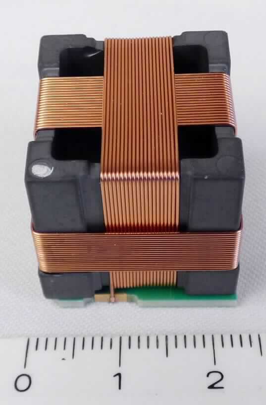 Transformator, sog. "Cubeantenna",
- aus drei unterschiedlichen, induktiv gekoppelten Kupferdrahtwicklungen auf einem 
  gemeinsamen Ferritkern in Kubusform (Abmessungen: 22 x 22 x 22 mm),
- auf einem Träger mit sechs Anschlusskontakten,
- mit einer Leistung von weniger als 1 kVA,
- zur Verwendung als Antenne;
- aufgemacht in einem Blistergurt oder in einer Blisterpalette.

Das Erzeugnis ist als "elektrischer Transformator, kein Transformator mit Flüssigkeitsisolation, mit einer Leistung von 1 kVA oder weniger, kein Messwandler, nicht von der TARIC-Unterposition 8504 3180 10 bis 8504 3180 50 erfasst" einzureihen.