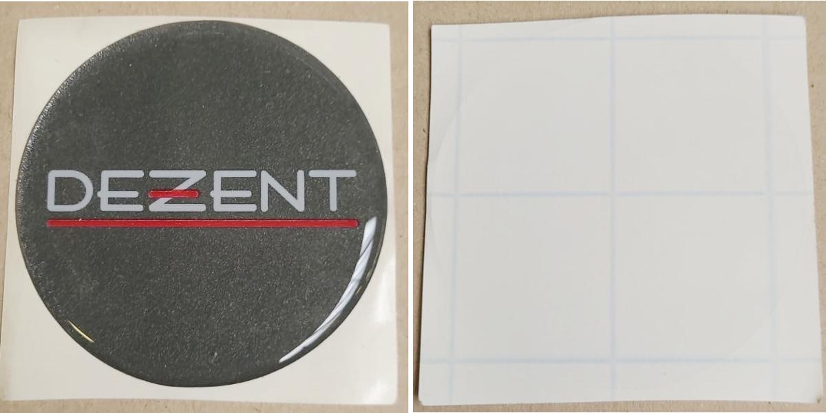 Es handelt sich um kreisrunde, bedruckte Aufkleber (Durchmesser etwa 60mm). Sie bestehen aus einem flexiblen, leicht gewölbten Kunststoff (Polyetherurethan) mit abgerundeten Rändern (somit kein selbstklebendes Flacherzeugnis der Position 3919) und sind schauseitig mit dem Logo eines Felgenherstellers bedruckt. Die Rückseite ist mit einer selbstklebenden Schicht (Acylatkleber) ausgerüstet und mit Schutzpapier abgedeckt. Die Klebelogos werden zu Zierzwecken auf dem blanko Nabenkappen von Automobilfelgen aufgeklebt. Sie sind gestapelt, lose in einem Karton verpackt.
 
Abbildung siehe Anlage.

Derartige Waren gehören als "andere als in den zuvor genannten TARIC-Codes aufgeführten Drucke" zum TARIC-Code 4911 9900 00.