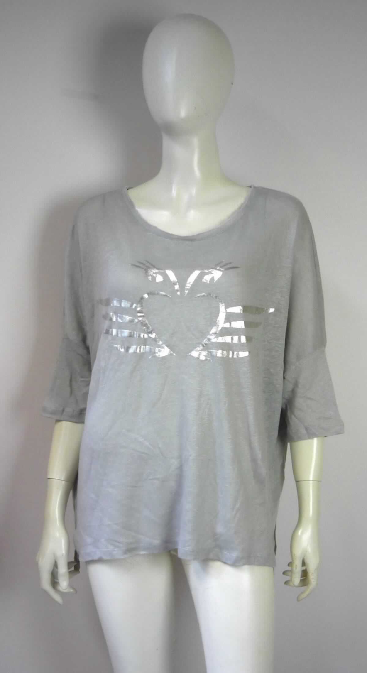 Modisches Unterhemd, sog. Damen T-Shirt, Größe S, Foto siehe Anlage,
- aus ca. 0,8 mm dicken (leichten), buntgewirkten Gewirken (melierte Garne) aus laut Antrag 100 % Leinen,
- über die Taille reichend (Rückenlänge: ca. 64 cm),
- mit einem halsfernen, runden Ausschnitt (somit kein T-Shirt),
- ohne Öffnung und ohne Verschluss,
- mit 3/4-langen Ärmeln,
- auf der Vorderseite mit einem Aufdruck verziert,
- modisch gestaltet, wird unmittelbar auf der Haut getragen,
- am unteren Rand durch Umschlagen und Festnähen gesäumt. 

"Unterhemd, aus Gewirken, aus Leinen"