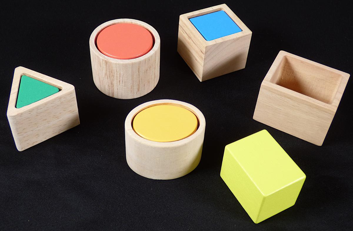 Spielzeug mit verschiedenen Funktionen, sog. "Formenlernspiel", bestehend aus
- fünf verschiedenen Bauklötzen aus Holz, farbig lasiert
-- in Form eines Zylinders, Würfels, Quaders, Ovals und Dreiecks
-- maximal ca. 4 x 4 x 3,5 cm groß
- fünf passgenauen Formen aus Holz zum Einstecken der Bauklötze
- ohne Hinweis auf Fertigung in Handarbeit
- dient der spielerischen Unterhaltung von Kindern.

Die Bauklötze und Kästchen können aufeinandergestapelt und somit sinnvoll alleine als Baukastenspielzeug bespielt werden. Ebenso können die Bauklötze in der Art eines Puzzles in die Kästchen gesteckt werden. Da die Ware gleichermaßen als Baukastenspielzeug sowie als Puzzle verwendet werden kann, ist sie in Anwendung der AV 3 c) i.V.m. der AV 6 die zuletzt genannte, in Betracht kommende Unterposition (KN) der KN einzureihen.

Die Ware wird zolltarifrechtlich als "Puzzle, aus Holz, nicht handgearbeitet" eingereiht.