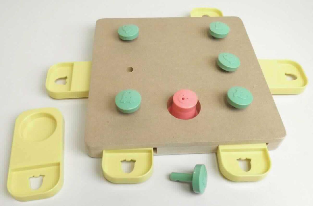 Cube Doggy Brain Train Hundespielzeug (Abbildung siehe Anlage)
- Tierspielzeug aus einem quadratischen Gehäuse aus Holzfaserplatten, 
- - auf der Vorderseite mit sechs Bohrlöchern zur Aufnehmen von sechs Steckpins aus
    Kunststoff sowie einer Aussparung als Versteckmöglichkeit für "Hundeleckerli" mit einem 
    abnehmbaren Abdeckhütchen aus Kunststoff,
- - auf den Längsseiten mit sechs Aussparungen zur Aufnahme von Kunststoffschiebern als 
    Versteckmöglichkeiten von "Hundeleckerli", 
- in einem Verkaufskarton für den Einzelverkauf aufgemacht,
- zur spielerischen Unterhaltung von Hunden (keine Ware der Position 9503).

Hinsichtlich der Bedeutung für die Verwendung und des Umfangs sind die Holzfaserplatten 
gegenüber dem Kunststoff charakterbestimmend.

"Andere als in den Positionen 4401 bis 4420 erfasste Waren aus Holz, kein Kleiderbügel, nicht 
aus Bambus, aus Faserplatten (zusammengesetzte Ware aus Faserplatten - charakterbestimmend - 
und Kunststoff)"