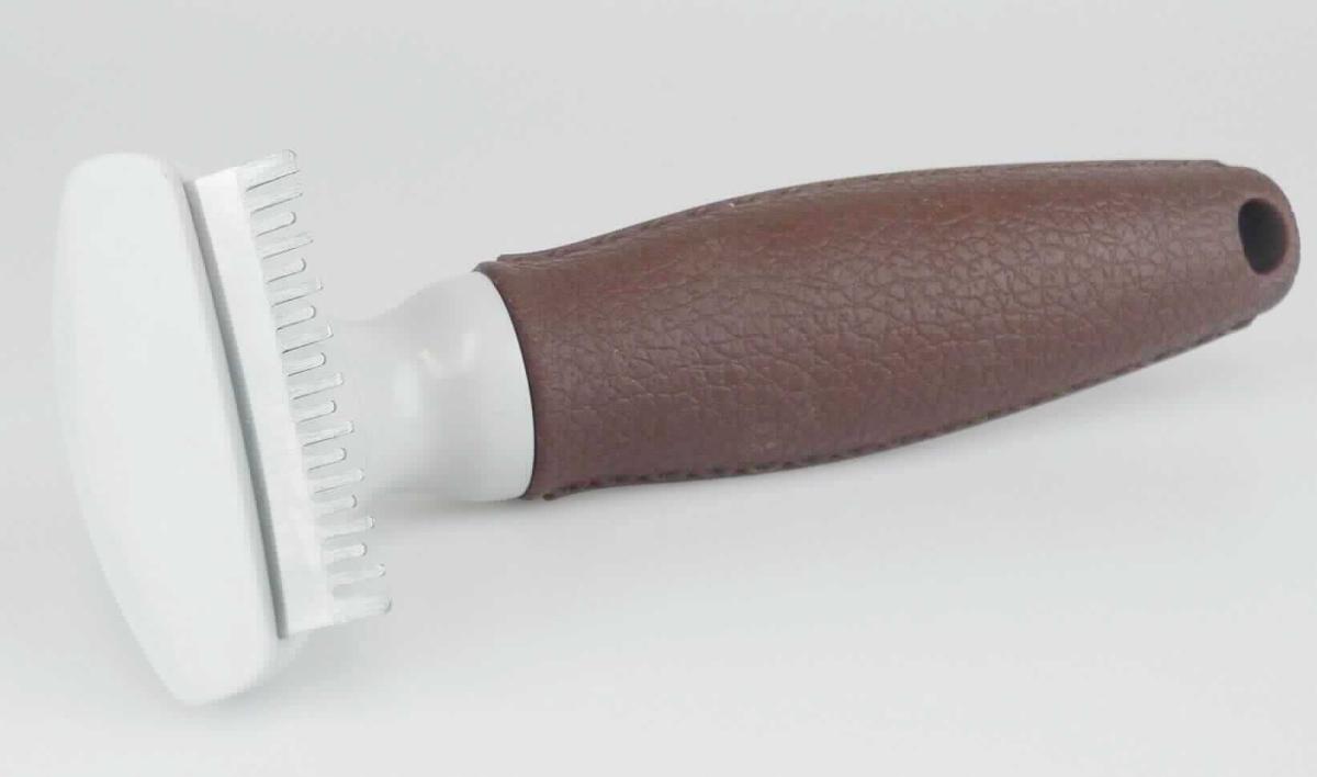 Bei dem sog. "Trimmstriegel / Spezialklinge Art. 65572" handelt es sich um einen Kamm zur Tierpflege; ca. 16 cm lang. Die aus verschiedenen Materialien zusammengesetzte Ware besteht aus einem Kunststoffgriff und Metallzinken (charakterbestimmend aufgrund der Bedeutung für die Verwendung).

Das Erzeugnis ist aufgrund seiner Form und Beschaffenheit erkennbar zur Pflege von Tieren bestimmt. Es dient der Pflege der Unterwolle, zum Entfilzen sowie Ausdünnen und entfernt das abgestorbene Haar.

Der Kamm ist für den Einzelverkauf auf einer bedruckten Pappkarte zum Aufhängen aufgeblistert. 

Die Ware ist als "Frisierkamm aus Metall" einzureihen.