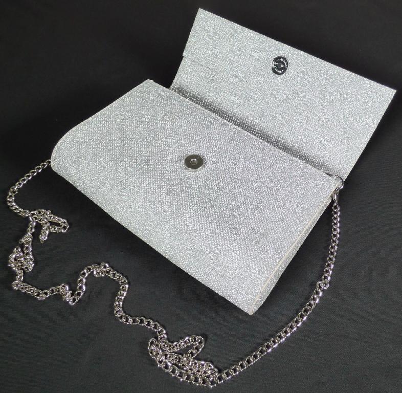 Handtasche, sog. Partytasche Glitzer, Foto siehe Anlage,
- mit einer Außenseite aus metallisierter Kunststofffolie (rautenförmig geprägt) auf einer Unterlage
  aus Vliesstoff (laut Untersuchungsergebnis),
- mit einem Schultertragegurt in Form einer abnehmbaren Gliederkette aus unedlem Metall,
- mit einer Überschlagklappe mit einem Magnetknopfverschluss,
- gefüttert; mit einem aufgesetzten, offenen Einsteckfach und einem eingesetzten Reißverschlussfach
  ausgestattet,
- in den Abmessungen von ca. 24 cm (Breite) x 16 cm (Höhe) x 5 cm (Tiefe),
- Handtasche, da aufgrund der Form, der Größe und des Gesamteindrucks in erster Linie dazu geeignet,
  kleinere, persönliche Gegenstände aufzunehmen.

"Handtasche, mit Außenseite aus Kunststofffolien"