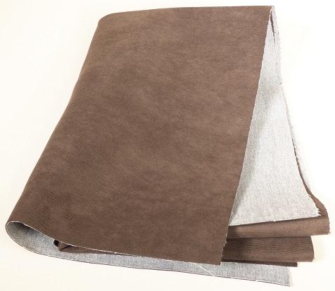 Textillaminat, sog. Möbelbezugstoff, Art. Belvedere, Foto siehe Anlage,
- als Meterware, mit einer Breite von laut Antrag 141 cm,
- laut Untersuchungsergebnis:
-- aus drei mit ihrer ganzen Fläche aufeinander liegenden und so miteinander verbundenen Lagen:
--- mit einer Außenlage aus einem buntgewebten und gerauten Gewebe aus synthetischen
    Chemiefasern,
--- mit einer Zwischenlage aus Zellkunststoff (laut Antrag Polyurethan),
--- mit einer Innenlage aus einem Gewebe aus synthetischen Chemiefasern,
- von Hand bei einer Temperatur zwischen 15 und 30 °C auf einen Dorn von 7 mm Durchmesser
  aufrollbar, ohne rissig zu werden.

"Gewebe, mit Kunststoff (Polyurethan) laminiert, anderes als solche der Position 5902, anderes
 als in der Unterposition 5903 2090 20 genannte"