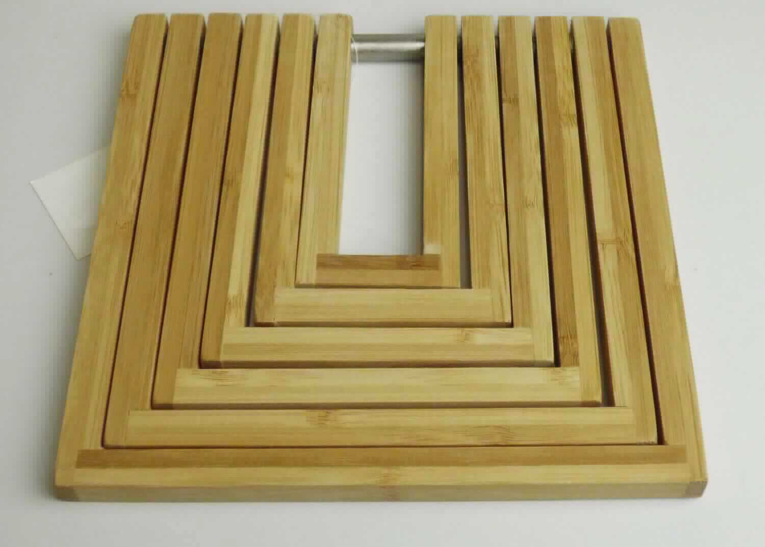 Topfuntersetzer Bamboo, Art. 25301,
- in rechteckiger Form, bestehend aus sechs U-förmigen Bambusleisten, die beweglich an einer Stange 
  aus unedlem Metall befestigt sind, in den Abmessungen ca. 19 x 19 x 1cm,
- zur Verwendung bei Tisch (z.B. zum Abstellen von heißem Kochgeschirr). 
(Abbildung siehe Anlage)

Aufgrund der Bedeutung für die Verwendung bestimmt das Holz den Charakter des Ganzen.

"Holzwaren zur Verwendung bei Tisch oder in der Küche, aus Bambus, weder Brotbretter, 
Schneidebretter und ähnliche Bretter noch Essstäbchen (zusammengesetzte Ware aus 
Holz - charakterbestimmend - und unedlem Metall) ; sog. Topfuntersetzer"