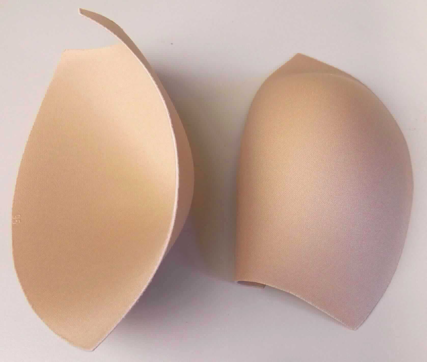 Teile für Büstenhalter, sog. Cups für die Büstenpartie von Badeanzügen bzw. Büstenhaltern, Foto siehe Anlage,
- aus ca. 4 mm dicken, dreilagigen Flächenerzeugnissen der Position 5903, mit Außenlagen aus einfarbigen
  (hautfarben) Gewirken aus laut Antrag 100 % Polyester (synthetische Chemiefasern) und einer mit dem bloßen 
  Auge wahrnehmbaren Zwischenlage aus Zellkunststoff,
- die einzelnen "Cups" sind annähernd rund zugeschnitten (somit konfektioniert) und durch Wärmeeinwirkung 
  konvex geformt (Durchmesser bis zu ca. 18 cm),
- laut Antrag dazu bestimmt, in die Büstenpartie von ein- oder zweiteiligen Badeanzügen sowie von Büstenhaltern 
  eingenäht zu werden; sie stellen sich somit gleichermaßen als Teile von Kleidung als auch als Teile von 
  Büstenhaltern dar und sind der von den gleichermaßen in Betracht kommenden Positionen (6117 / 6212) in der 
  Nomenklatur zuletzt genannten zuzuweisen.

"Teile von Büstenhaltern, aus Gewirken"