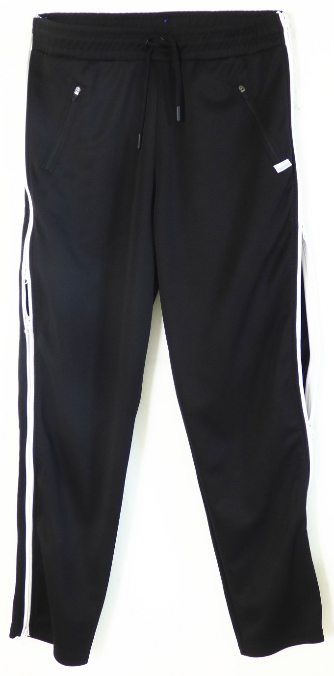 Lange Hose, Größe M, Foto siehe Anlage,
- aus ca. 0,7 mm dicken, einfarbigen Gewirken aus laut Antrag 100 % Polyester
  (synthetische Chemiefasern),
- in der Taille abschließend, mit einem doppelt gearbeiteten Taillenbund, in den vorn und hinten
  ein sog. Gumiband eingenäht ist; vorn zusätzlich mit einem Tunnelzug ausgestattet,
- vorn ohne Öffnung und ohne Verschluss,
- ohne Hinweise auf den Trägerkreis (unisex),
- vorn mit zwei eingesetzten Taschen mit Reißverschluss,
- an den Außenseiten mit jeweils einer vom oberen Rand des Taillenbundes bis zu den Hosenbein-
  abschlüssen reichenden Öffnung mit Reißverschluss versehen; durch kontrastfarbene
  Paspelierungen aus Gewirken aus Spinnstoffen weitestgehend verdeckt,
- mit knöchellangen Hosenbeinen; an den Hosenbeinabschlüssen durch Umschlagen und
  Festnähen gesäumt.

"Lange Hose, aus Gewirken, für Frauen, aus synthetischen Chemiefasern"