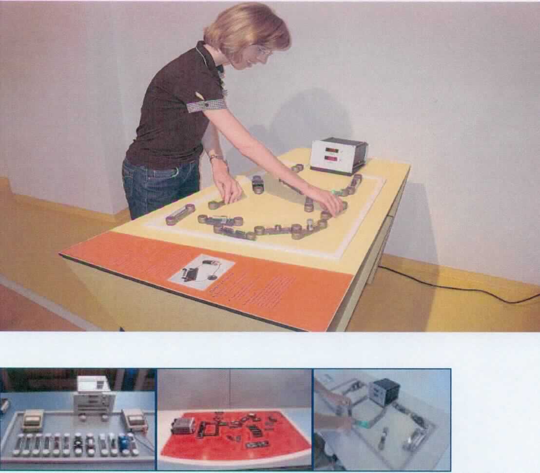 Bei dem Erzeugnis mit der Bezeichnung "Circuits" handelt es sich nach Beschaffenheit und vorgesehener Verwendung nach um ein Exponat zu Vorführzwecken in Museen, Science Centern und ähnlichen Einrichtungen, das zur ausschließlichen Wissensvermittlung von wissenschaftlichen Phänomenen und Ergebnissen dient.
Das Exponat "Circuits", Seriennummer 9630, erklärt experimentell die Wirkung von Schaltkreisen, die auf einer sog. Workstation, durch Kabel mit einer Vielzahl von elektrischen und elektronischen Bauelementen sowie Geräten wie Ventilatoren, LED-Spots, Lichtschranken durch berechnetes Verdrahten des Betrachters / Besuchers verschaltet werden. 
Wesentliche Bestandteile des Exponats (noch nicht zusammengesetzt):
Grundkörper als Arbeitsplatz (Workstation) aus Birkensperrholz, mit Netzteil, Kabeln, elektrischen und elektronischen  Bauelementen sowie vorgenannten Elektroartikeln, Gewicht zwischen 20 und 25 kg. 

Die Ware ist als "Instrument, Apparat, Gerät und Modell, seiner Beschaffenheit nach zu Vorführzwecken bestimmt, nicht zu anderer Verwendung geeignet, nicht von dem TARIC-Code 9023 0010 00 erfasst" einzureihen.

Anlage: 1 Abbildung