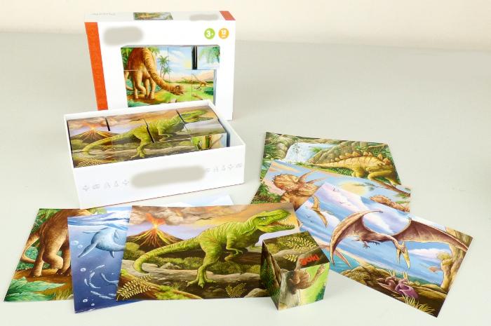 Bei der durch ein Warenmuster veranschaulichten und als "Würfelpuzzle Dinosaurier - Artikel 57388" bezeichneten Ware handelt es sich um ein Spielzeug in Form einer Warenzusammenstellung in Aufmachung für den Einzelverkauf bestehend aus
- einem Puzzle für Kleinkinder, das aus zwölf Würfeln aus Holz
  (Kantenlänge ca. 3,5 cm) gebildet wird, deren sechs Seiten mit
  unterschiedlichen Motiven aus Papier beklebt sind,
-- ohne Hinweise auf eine Fertigung in Handarbeit,
- sechs Druckerzeugnissen in Form von Puzzlevorlagen aus Papier,
  die jeweils mit einem Dinosaurier-Motiv bedruckt sind und das
  Zusammensetzen der Würfel zu den entsprechenden Motiven erleichtern
  sollen.
Die Waren sind gemeinsam in einer bedruckten Pappschachtel für den Einzelverkauf aufgemacht.

Insbesondere im Hinblick auf den Umfang und die Bedeutung für die Verwendung zur spielerischen Unterhaltung von Kindern verleiht das Würfelpuzzle den Charakter der Warenzusammenstellung. 

Die Würfel stellen sich zolltarifrechtlich als eine aus verschiedenen Stoffen zusammengesetzte Ware dar. Das Holz gibt dabei der Ware die Form, das bedruckte Papier ist jedoch im Hinblick auf den Verwendungszweck als Puzzle ausschlaggebend, da die verschiedenen aufgedruckten Motive passend zusammengelegt werden müssen. Im Hinblick auf die Verwendung und den Umfang ist somit kein charakterverleihender Stoff festzustellen. In Anwendung der AV 3 c) und der AV 6 ist die Ware daher der letztgenannten der gleichermaßen in Betracht kommenden Unterpositionen (KN) (9503 0061 und 9503 0069) zuzuweisen.

Derartige Erzeugnisse werden zolltarifrechtlich als "Puzzle aus anderen Stoffen als Holz" eingereiht.