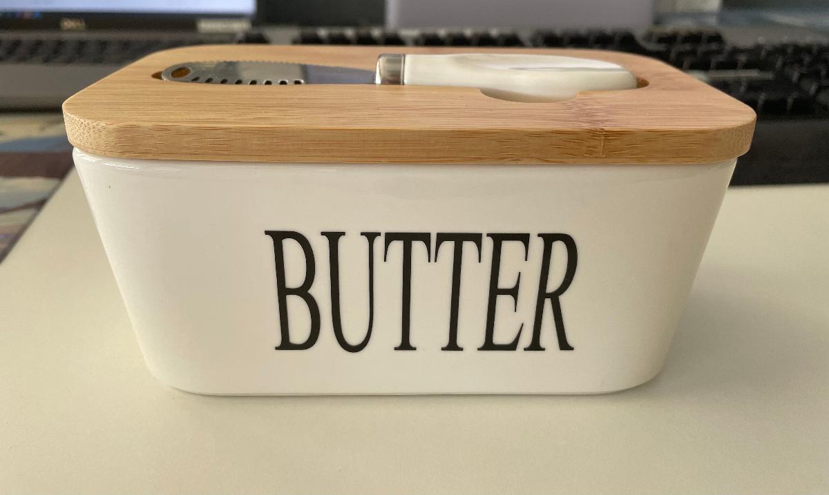 Warenzusammenstellung, bestehend aus Geschirr aus Porzellan (Butterdose) und
einem Buttermesser, sog. Butterdose, Foto siehe Anlage,
- in Aufmachung für den Einzelverkauf,
- zur Befriedigung eines speziellen Bedarfs zusammengestellt,
- Geschirr aus Porzellan (Butterdose); in Form einer zusammengesetzten Ware, bestehend
  aus:
- - einer rechteckigen (mit abgerundeten Ecken), glasierten, weißen Dose; außen an einer
    Längsseite mit der Aufschrift "BUTTER" versehen,
- - - keramisches Erzeugnis; nach der Formgebung gebrannt; tonmineralhaltiges Material
      enthaltend,
- - - lt. Antrag aus Porzellan,
- - einem Deckel aus Holz (Bambus),
- - - passgenau zum Verschließen der Dose gearbeitet,
- - - mit einem Dichtungsring aus Kunststoff versehen,
- - - auf der Außenseite mittig mit einer passgenauen Vertiefung zur Aufnahme des
      Buttermessers,
- - in den Abmessungen: 16 cm (Länge) x 9 cm (Breite) x 8 cm Höhe),
- - die Dose aus Keramik verleiht der zusammengesetzten Ware nach dem Umfang und der
    Bedeutung in Bezug auf die Verwendung den wesentlichen Charakter,
- Buttermesser,
- - mit einer Klinge aus unedlem Metall (charakterbestimmend) und einem Griff aus Keramik,
- - mit einer Länge von ca. 13 cm,
- - in der passgenauen Vertiefung im Deckel der Butterdose eingelegt,
- das Geschirr aus Porzellan (Butterdose) verleiht der Warenzusammenstellung insbesondere
  nach der Bedeutung in Bezug auf die Verwendung und dem Umfang den wesentlichen
  Charakter.

"Geschirr (Butterdose), aus Porzellan"