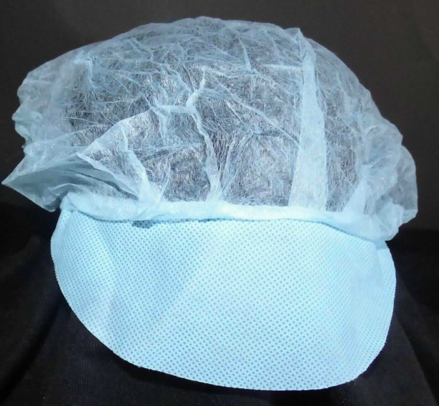 Kopfbedeckung, sog. Barett-Haube mit Schirm, Foto siehe Anlage, 
- in zwei verschiedenen Farben,
- aus einem Zuschnitt aus Vliesstoff aus synthetischen Spinnstoffen hergestellt, 
- mit einem maximalen Durchmesser von ca. 48 cm, 
- am gesäumten Rand mit einem eingezogenen, elastischen Gummiband ausgestattet, 
- mit Schirm (aus Vliesstoff), 
- zur Verwendung als Schutzhaube zum Bedecken des gesamten Haares.

"Kopfbedeckung, aus einem Stück von Spinnstofferzeugnissen hergestellt, Mütze, mit Schirm"