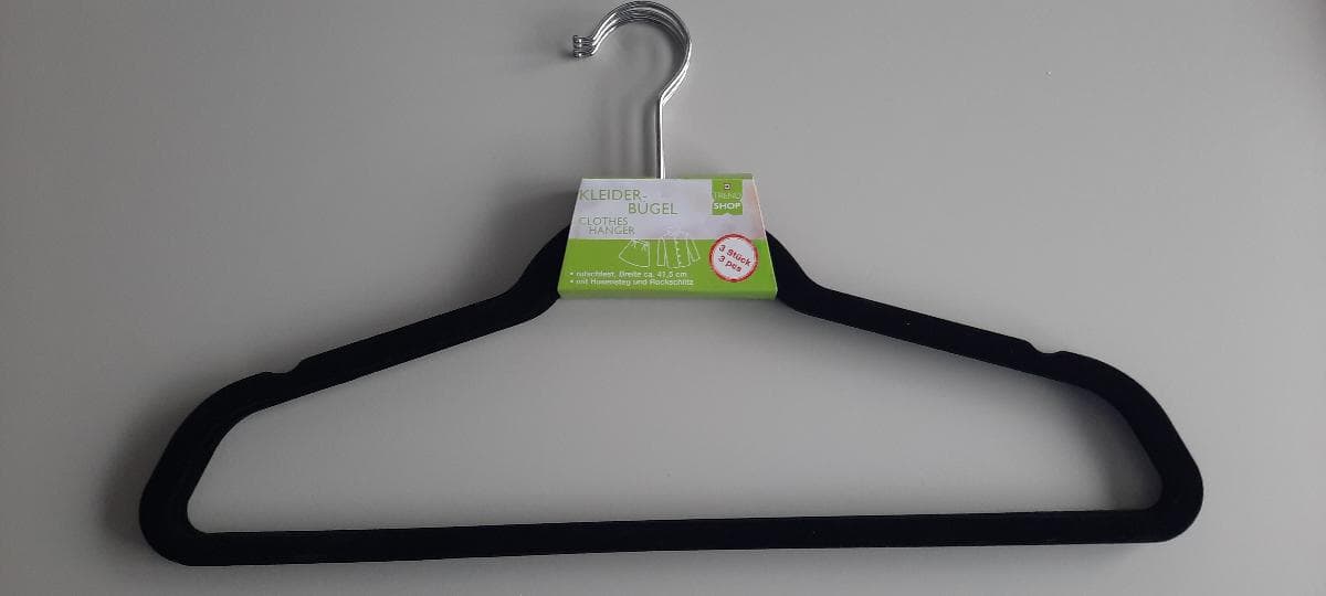 Nach den Antragsangaben sowie dem vorgelegten Warenmuster handelt es sich um mit Scherstaub beflockte Kleiderbügel aus Kunststoffen im Sinne der Anmerkung 1 zu Kapitel 39.
 
Das etwa 41,5 cm breite Erzeugnis ist mit einem Aufhängehaken aus unedlem Metall versehen und zeichnet sich am oberen Bügelrand durch zwei Einkerbungen (sog. Rockkerben) sowie am unteren Rand durch einen Hosensteg aus. Es dient dem Aufhängen von Kleidungsstücken, sowohl in Haushalten als auch im gewerblichen Bereich.
 
Im Hinblick auf die Bedeutung in Bezug auf die Verwendung und den Umfang bestimmen die Kunststoffe den Charakter der aus verschiedenen Stoffen bestehenden Ware. 
 
Die als 3er-Set mit einer bedruckten Pappbanderole aufgemachte Ware wird zolltarifrechtlich als "Hauswirtschaftsartikel aus Kunststoffen; nicht von den TARIC-Codes 3924 1000 11 bis 3924 9000 10 erfasst" eingereiht.