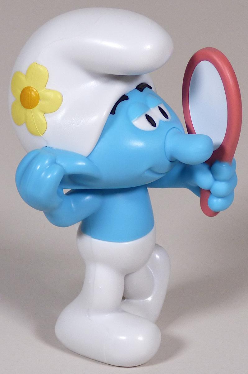 Bei dem vorliegenden und als "Smurfs Vanity, Art. 17997B" bezeichneten Erzeugnis handelt es sich um ein Spielzeug,
- ein humanoides, nicht menschliches Wesen mit blauer Hautfarbe darstellend (sog. "Schlumpf"),
- aus starrem Kunststoff gefertigt, somit ungefüllt,
- ca. 8,6 cm hoch,
- mit einem Kopf, zwei Armen, einem angedeuteten Schwanz und zwei Beinen versehen,
- mit einer nicht abnehmbaren Mütze sowie einer Hose bekleidet,
- das Wesen hat in der linken Hand einen stark stilisierten Handspiegel und hält diesen vor
  das eigene Gesicht,
- dient der spielerischen Unterhaltung von Kindern,
- in einem Polybeutel verpackt.

Derartige Erzeugnisse werden zolltarifrechtlich als "Spielzeug, ein nicht menschliches Wesen darstellend, nicht gefüllt, nicht aus Holz handgearbeitet" eingereiht.