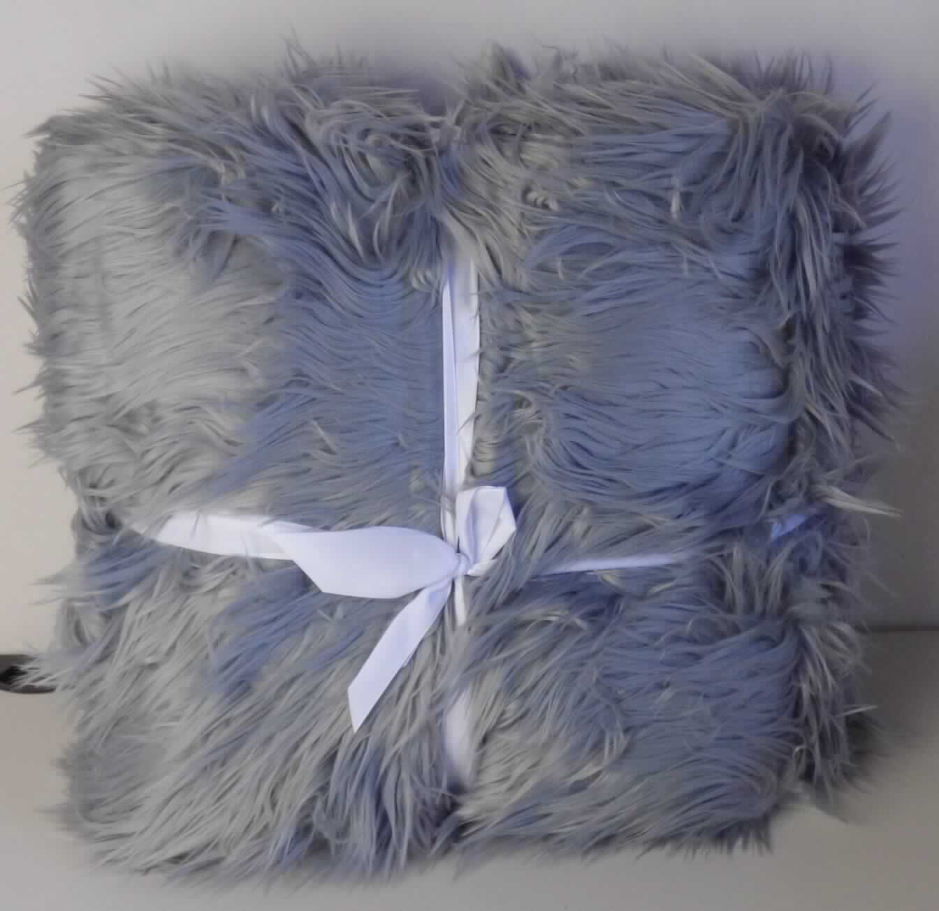 Decke, sog. Kuscheldecke "Grace", Foto siehe Anlage,
- mit einer umgebundenen Schleife mit aufgezogener, bedruckter Pappkarte versehen,
- rechteckig, in den Abmessungen von laut Antrag: 150 cm x 200 cm,
- zweilagig gearbeitet, mit einer Lage (Schauseite) aus langflorigen Plüschgewirken aus laut Antrag 80 % Polyacryl 
  und 20 % Polyester (beides synthetische Chemiefasern) und einer Lage aus einfarbigen Samtgewirken aus laut 
  Antrag 100 % Polyester,
- an den Rändern zusammengenäht (somit konfektioniert),
- ohne elektrische Heizvorrichtung.

"Decke, aus Spinnstoffen, ohne elektrische Heizvorrichtung, aus synthetischen Chemiefasern, aus Gewirken"