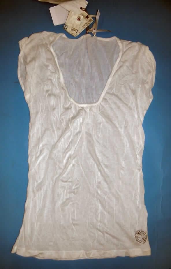 Modisches Unterhemd, sog. Bluse, Größe  36/S, siehe Foto,
- aus 0,5 mm dicken (leichten), einfarbigen und leicht durchscheinenden Gewirken aus laut
  Antrag 100% synthetischen Chemiefasern,
- über die Taille reichend (Rückenlänge: 65 cm),
- vorn mit einem runden, halsfernen, jedoch nicht sehr tiefen Halsausschnitt mit schmaler
  Randeinfassung (der Halsausschnitt unterschreitet nicht die imaginäre Linie zwischen den
  Achselhöhlen, somit u.a. kein Kleidungsstück der Position 6106),
- ohne Öffnung und ohne Verschluss,
- mit sehr kurzen Ärmeln, sog. überschnittenen Schultern,
- modisch gestaltet, vorne am oberen Rand gerafft,
- wird unmittelbar auf der Haut getragen,
- am unteren Rand gesäumt.