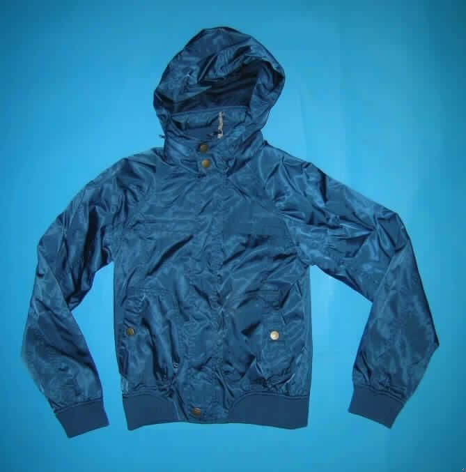 Blouson für Männer, sog. Windjackenähnliches Kleidungsstück, Größe 36/S, siehe Foto,
- aus 0,3 mm dicken, einfarbigen Geweben aus laut Antrag 100% synthetischen
  Chemiefasern,
- über die Taille reichend (Rückenlänge: 59 cm), 
- mit einem Stehkragen, mit einer im Kragen verstaubaren Kapuze,
- vorn mit einer durchgehenden Öffnung mit Reißverschluss mit Druckknopfpatte von links
  auf rechts (Männerkleidung),
- mit langen Ärmeln, die über den unteren Rand des Kleidungsstücks hinausreichen;
  mit angesetzten, verengenden, gerippt gewirkten Bündchen,
- vorn rechts mit einer eingesetzten Brusttasche mit Reißverschluss und zwei aufgesetzten
  Taschen mit Knopfverschluss unterhalb der Taille,
- durchgehend gefüttert,
- am unteren Rand mit einem verengenden, teilweise angesetzten Bund aus gerippten
  Gewirken (u.a. somit keine Kleidung der Position 6206),
- erfüllt aufgrund des Schnitts und der Ausstattung die Voraussetzungen zur Einreihung als
  Blouson (somit keine Jacke der Position 6204).