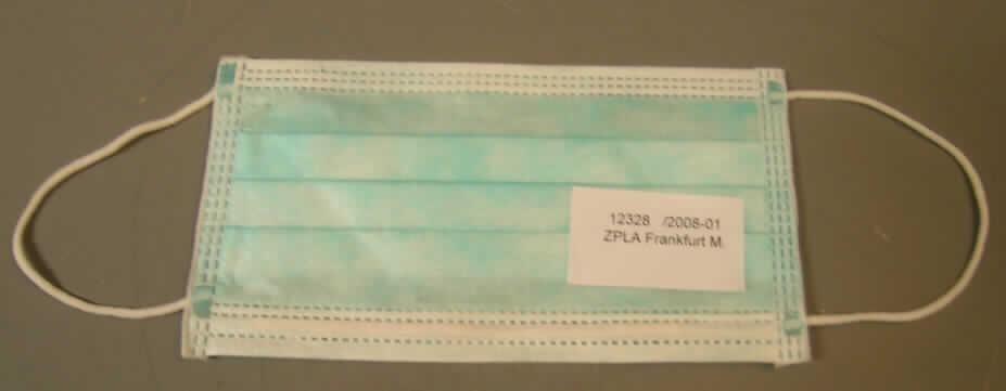 Andere konfektionierte Ware, sog. OP-Maske, siehe Foto,
- laut Antrag in einer Faltschachtel (Inhalt: 50 Stück) für den Einzelverkauf aufgemacht,
- rechteckig; in den Abmessungen: etwa 18 cm x 9,5 cm,
- dreilagig; mit einer Gesamtdicke von etwa 0,6 mm; mit zwei Außenlagen und einer
  Zwischenlage aus Vliesstoff aus Spinnstoffen,
- in Falten gelegt, 
- im Nasenbereich mit einem eingearbeiteten Draht aus unedlem Metall verstärkt,
- an den Rändern umgeschlagen,
- an den Schmalseiten mit angenähten, elastischen Kordeln, welche zur Befestigung
  am Kopf dienen (u. a. dadurch konfektioniert).