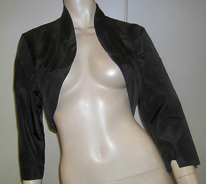 Andere Kleidung, sog. Bolero "Model 289", Größe 38, siehe Foto,
- aus 0,2 mm dicken, einfarbigen Geweben aus lt. Antrag 65 % Acetate und 35 % 
  Polyester (beides Chemiefasern), 
- oberhalb der Taille endend (Rückenlänge: ca. 40 cm), vorn kürzer gearbeitet,
- mit einem Stehkragen,
- vorn mit einer durchgehenden Öffnung ohne Verschlusssystem (u. a. somit keine 
  Ware der Position 6206), 
- ohne Merkmale, die auf den Trägerkreis schließen lassen (unisex),
- mit 3/4-langen Ärmeln,
- ungefüttert,
- im unteren Bereich doppelt gearbeitet,
- kennzeichnet sich u. a. aufgrund des dünnen Materials, des Schnitts und der 
  Ausstattung auch nicht als Jacke der Position 6204.