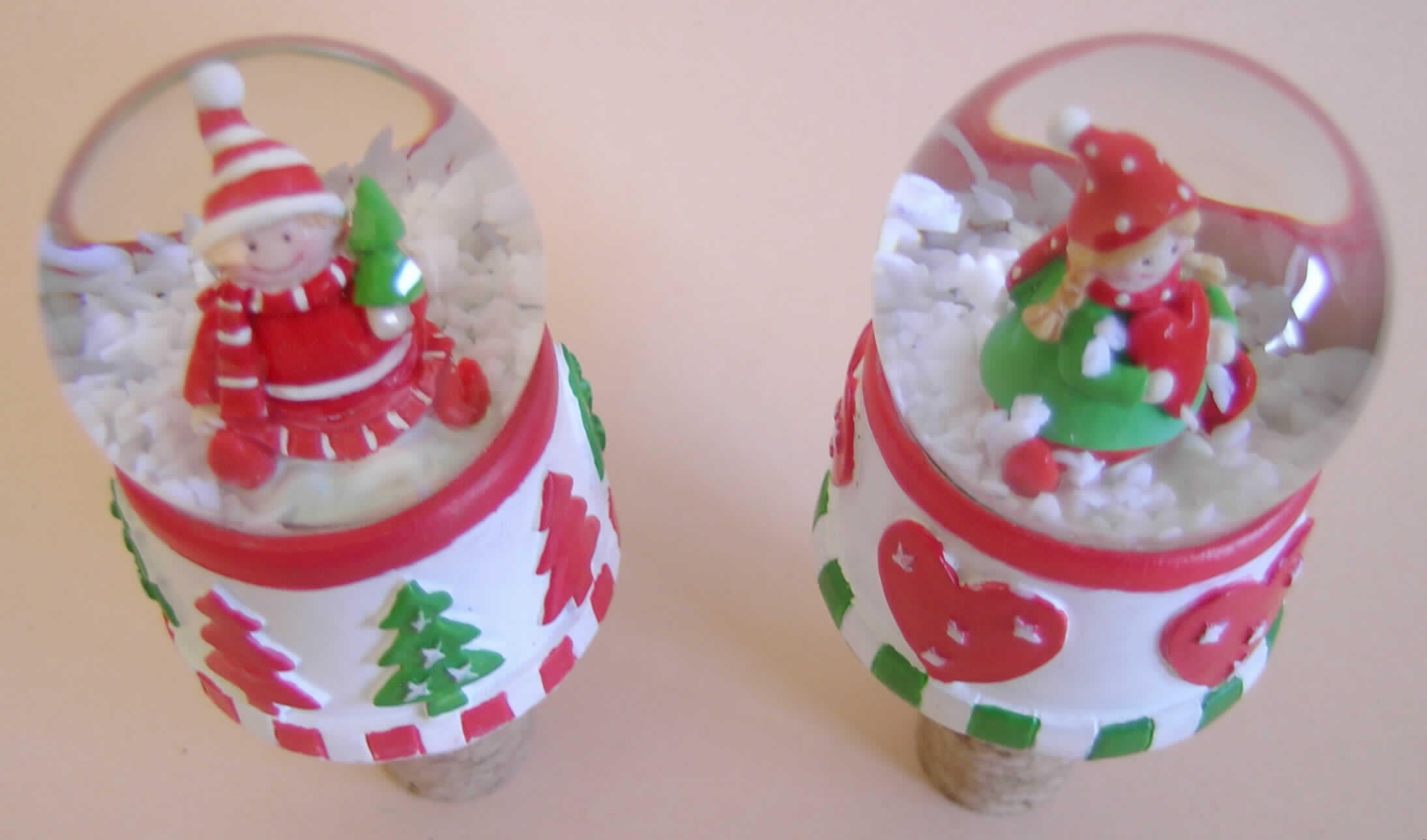 "Flaschenstopfen Wichtel"
Der Flaschenkorken besteht aus einem ca. 35 mm langen, konischen (kegelförmigen) Stopfen aus Presskork und einer ca. 50 mm großen Schneekugel, die durch Kleben mit dem Stopfen fest verbunden ist.
Die Schneekugel besteht aus einem runden Kunststoffsockel und einer Glaskuppel, die im Inneren mit einer knabenhaften Wichtelfigur, weißen Kunstschneeflocken und klarer Flüssigkeit befüllt ist. Trotz des erheblichen Ziercharakters der Ware gewährleistet der Presskorkstopfen die für die Verwendung des Erzeugnisses maßgebliche Verschlussfunktion und ist daher als charakterverleihend anzusehen.