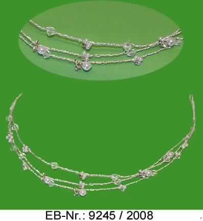 "Brautkopfschmuck"; es handelt sich um Haarschmuck in Form eines dreiteiligen Reifes aus dekorativ umeinander gewickelten Drähten aus unedlem Metall, die mit aufgezogenen rhombenförmigen, facettenartig geschliffenen Kunststoffperlen sowie runden Kunststoffperlen mit unterschiedlichem Durchmesser und kleinen Glassteinen versehen sind.

Der Charakter der aus verschiedenen Stoffen zusammengesetzten Waren wird aufgrund des Umfangs und des Wertes (lt. Antragstellerangabe) durch das unedle Metall bestimmt. 
Die Erzeugnisse sind in einem Kunststoffbeutel verpackt.

Abbildung siehe Anlage.

Derartige Erzeugnisse gehören als "anderer Fantasieschmuck" zur Codenummer 7117 9000 00 des Integrierten Zolltarifs der EG (TARIC).