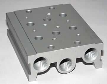 Mehrfachanschlussplatte
- aus einem Aluminium-Körper mit integrierten Kunststoff-Dichtungen, Anschlüssen zur 
  Druckluftversorgung bzw. Entlüftung, Bohrungen zur Ventil-Fixierung, seitlichen
  Schwalbenschwanz-Führungen für Ventilsteuerung-Befestigung (Abbildung siehe Anlage),
- zur Aufnahme und zum Anschluss von zwei Magnetventilen zur pneumatischen
  Kraftübertragung.

"Teil, erkennbar ausschließlich für Ventil zur pneumatischen Energieübertragung bestimmt - 
Mehrfachanschlussplatte für Pneumatikventil"